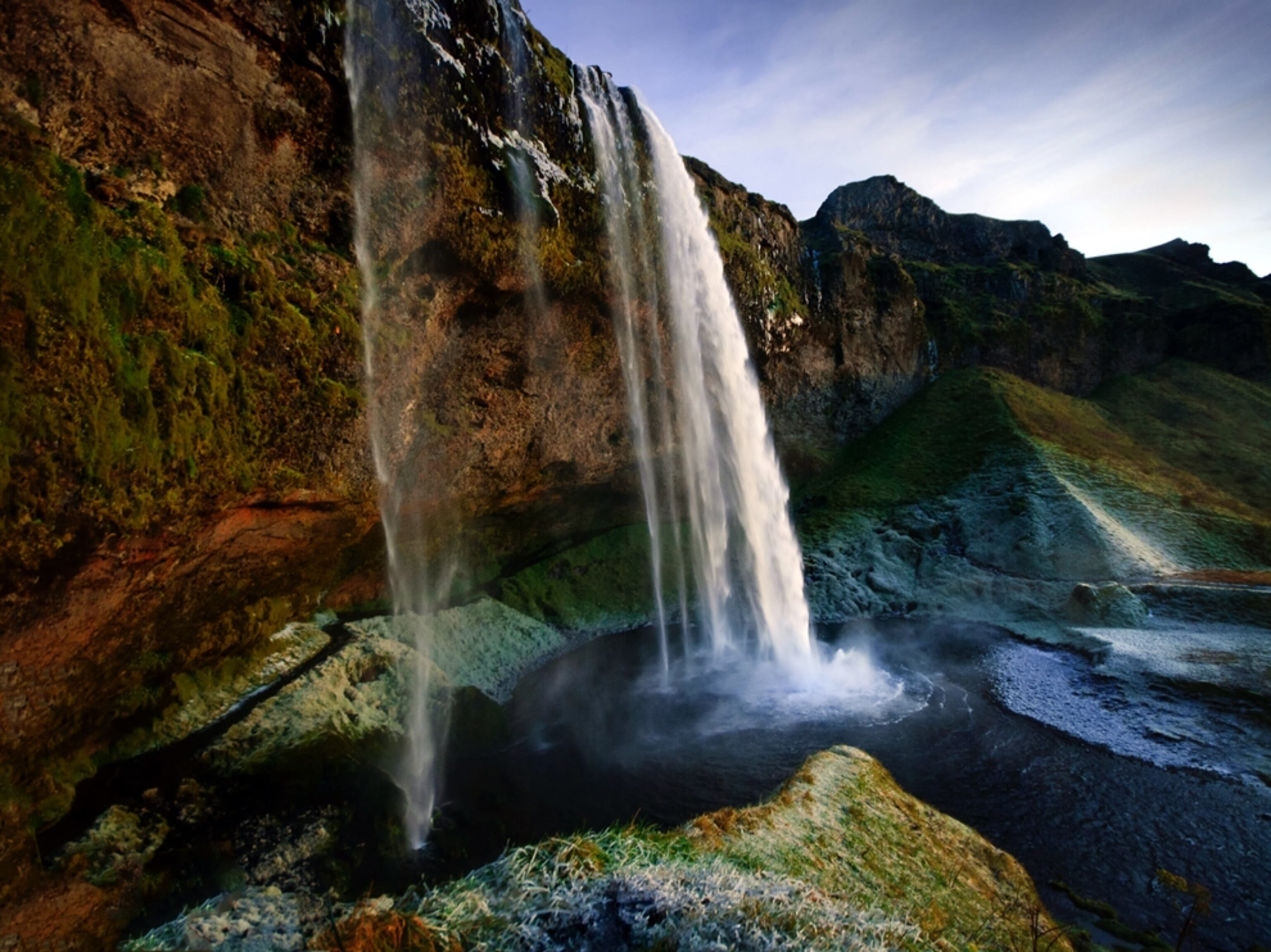 Seljalandsfoss covered in ice in early winter morning