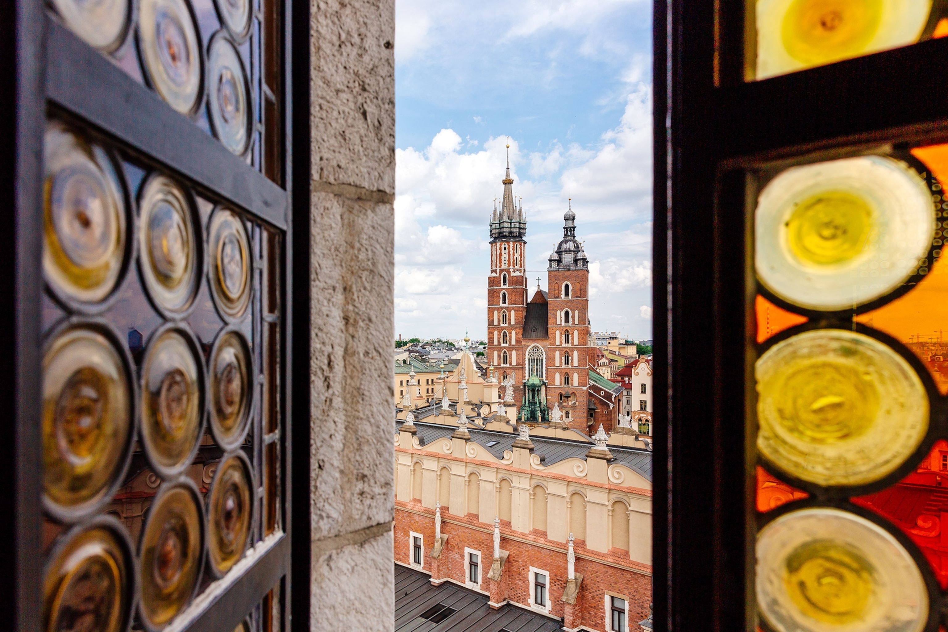 View through a stained glass window at a historic center with red brick