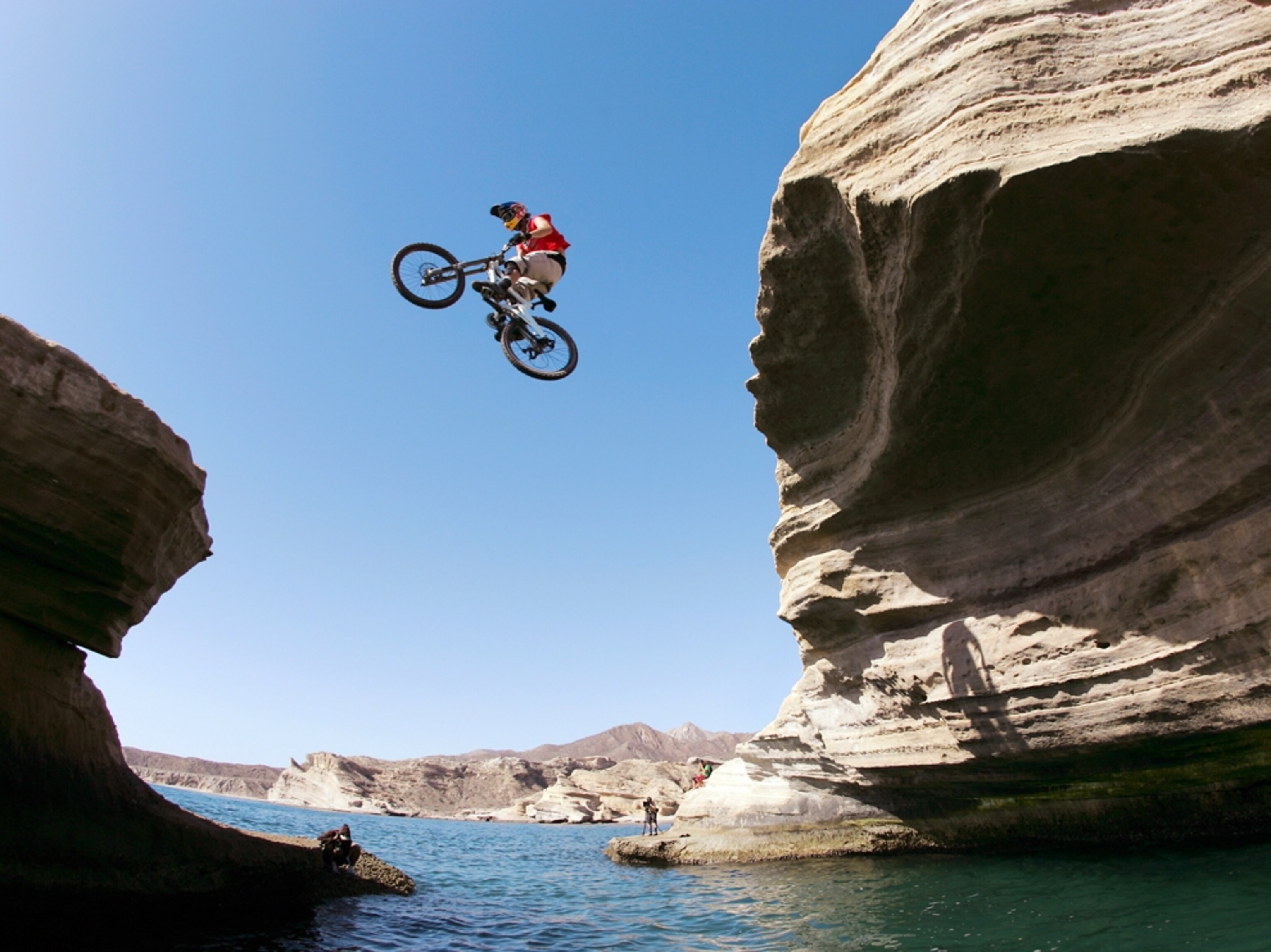 Biker jumping from cliff to cliff