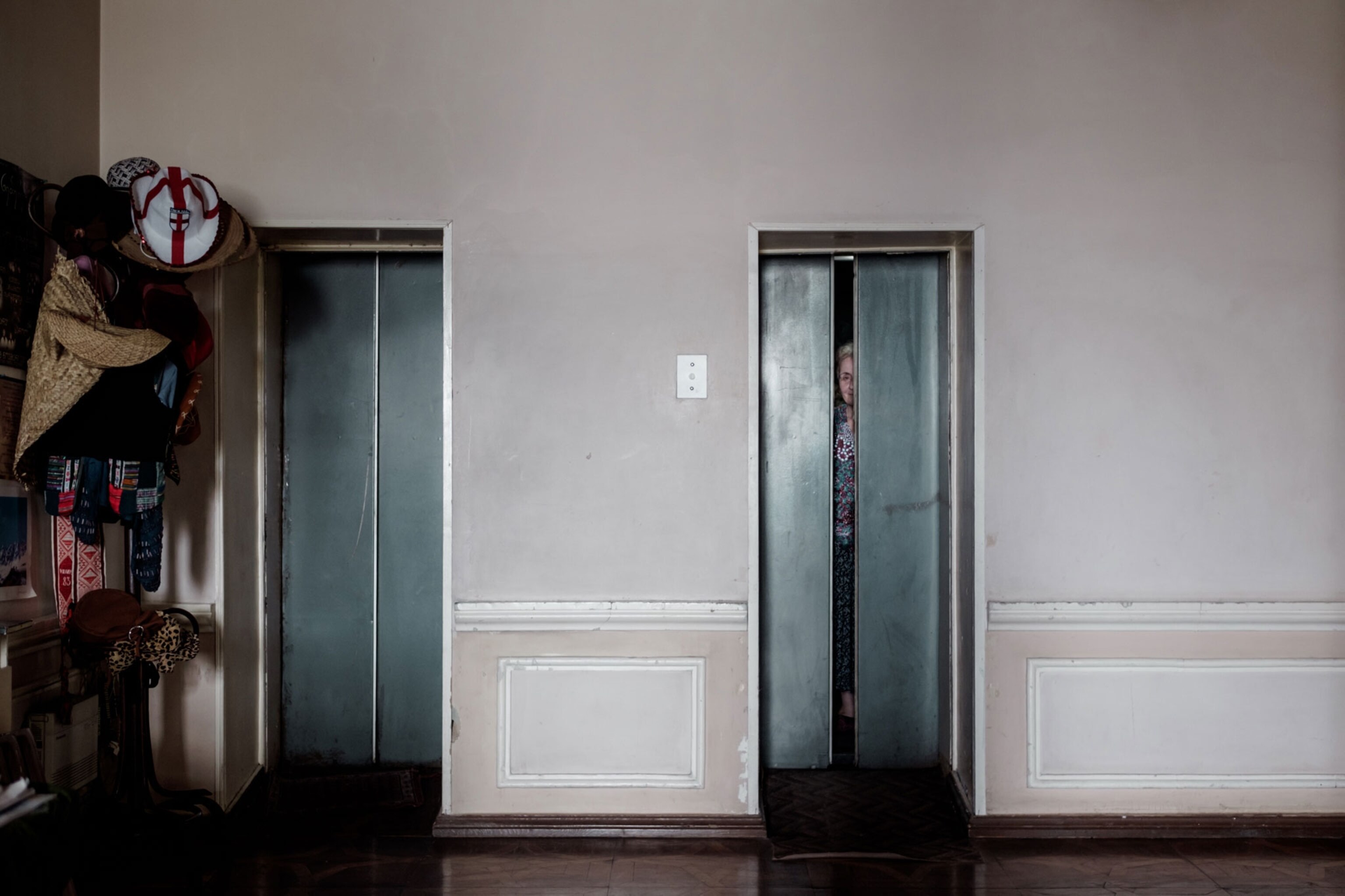 Larissa peaks through an elevator door after a days work at Hotel Georgia