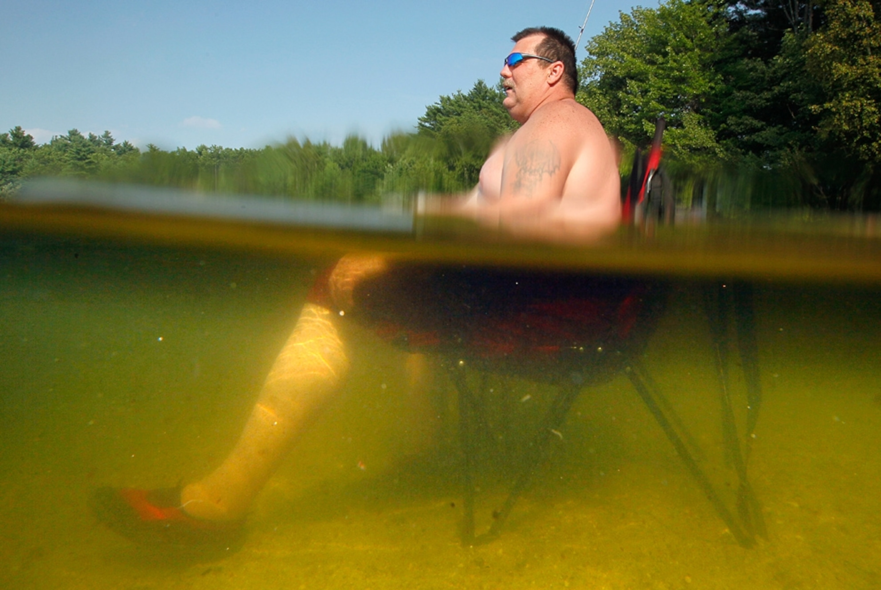 William Dyer sits in a beach chair in Sabbathday Lake in New Gloucester, Maine.