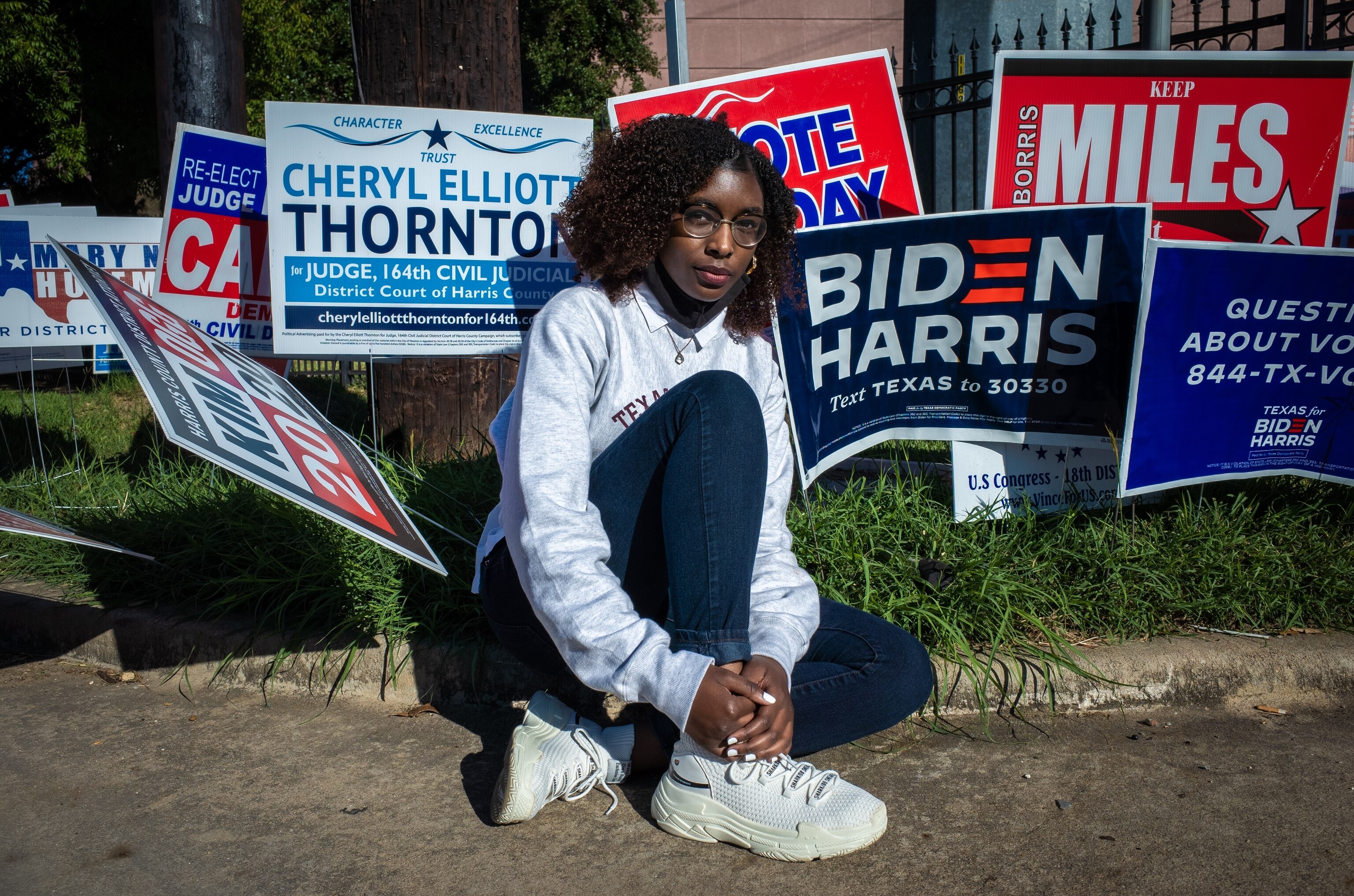 a woman in front of voting signs in Austin Texas