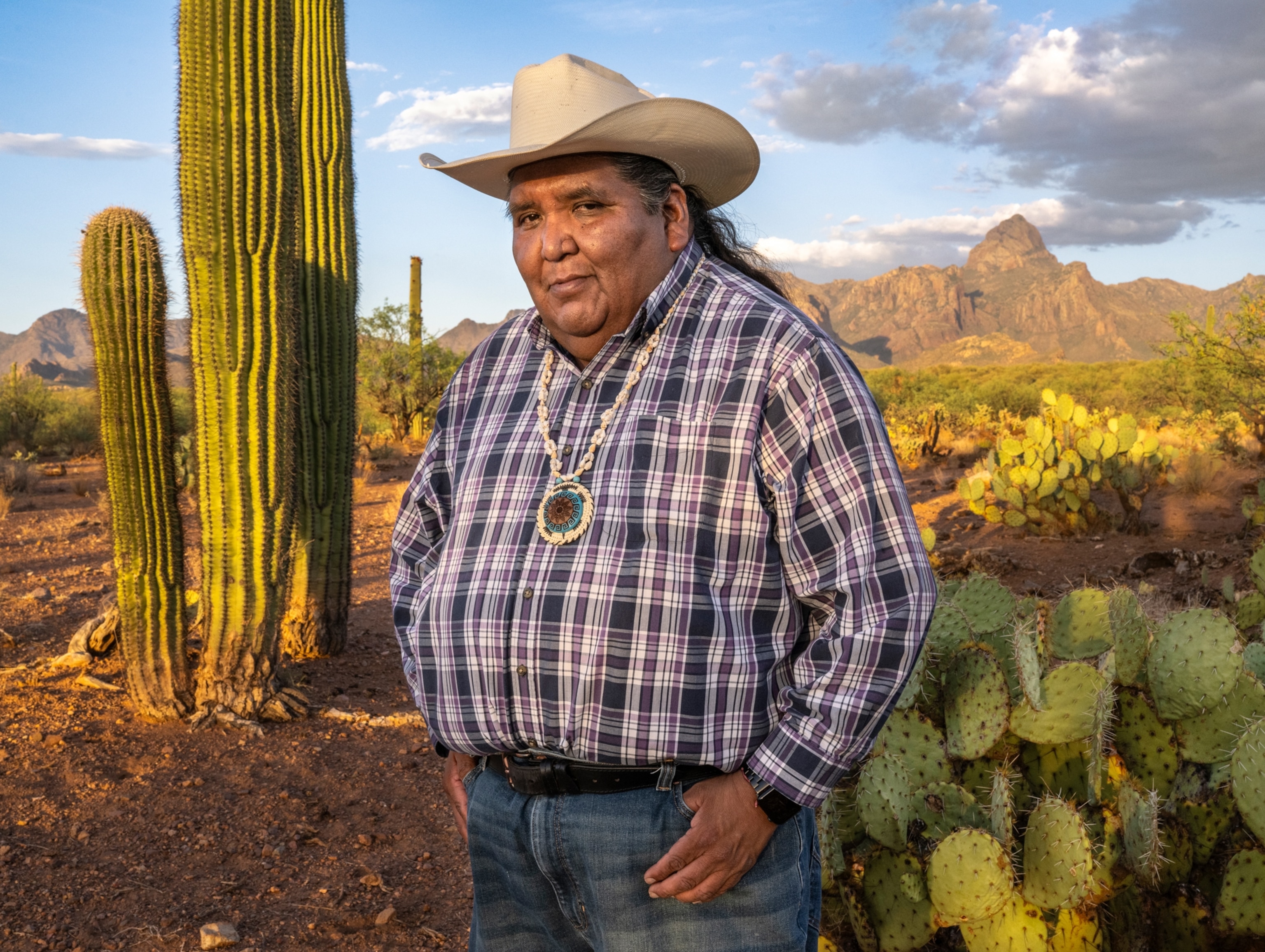 Chairman Verlon M. Jose stands with Baboquivari Peak rising behind him