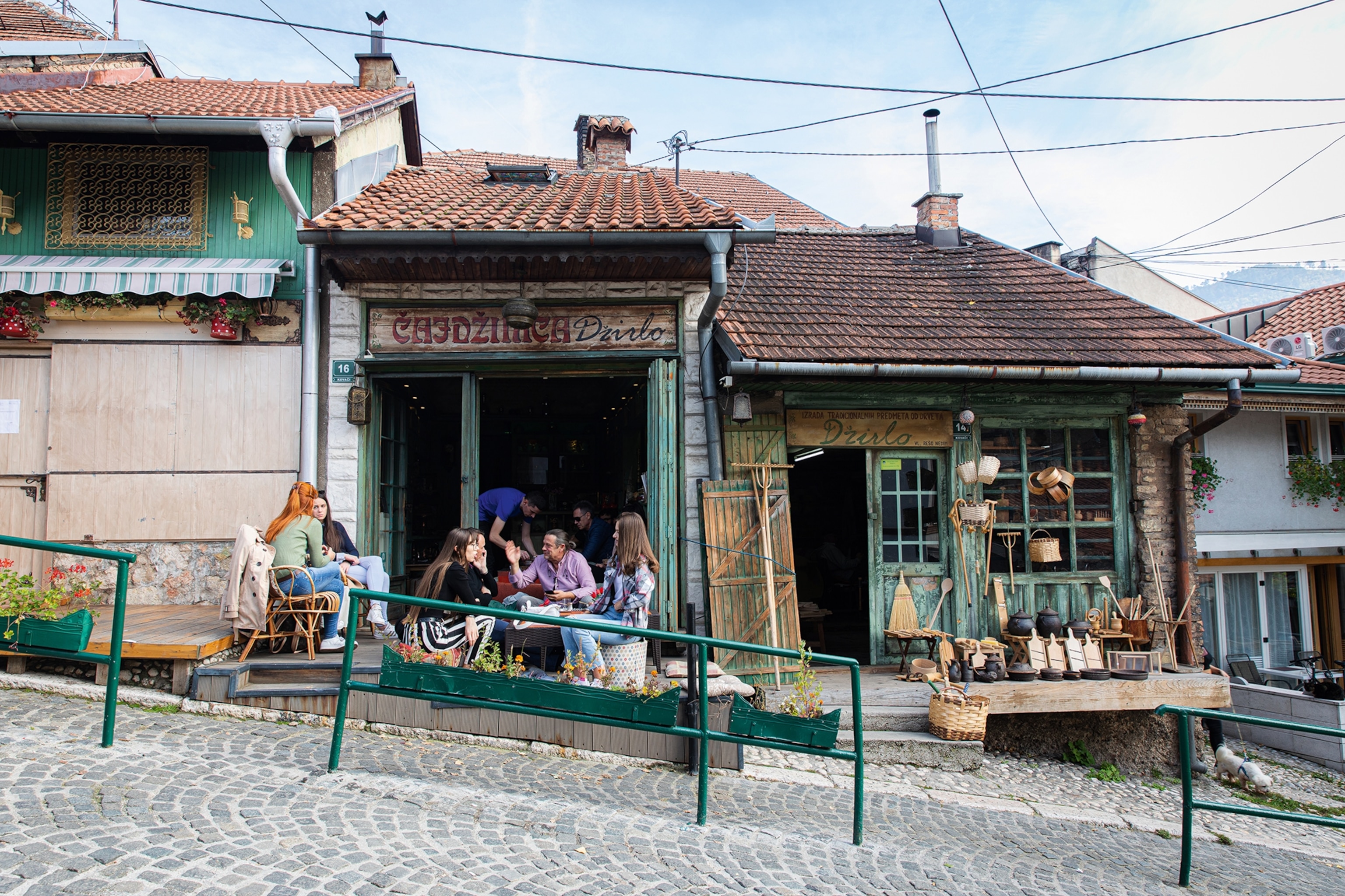 People outside a cafe on cobbled Kovači Street near the centre.