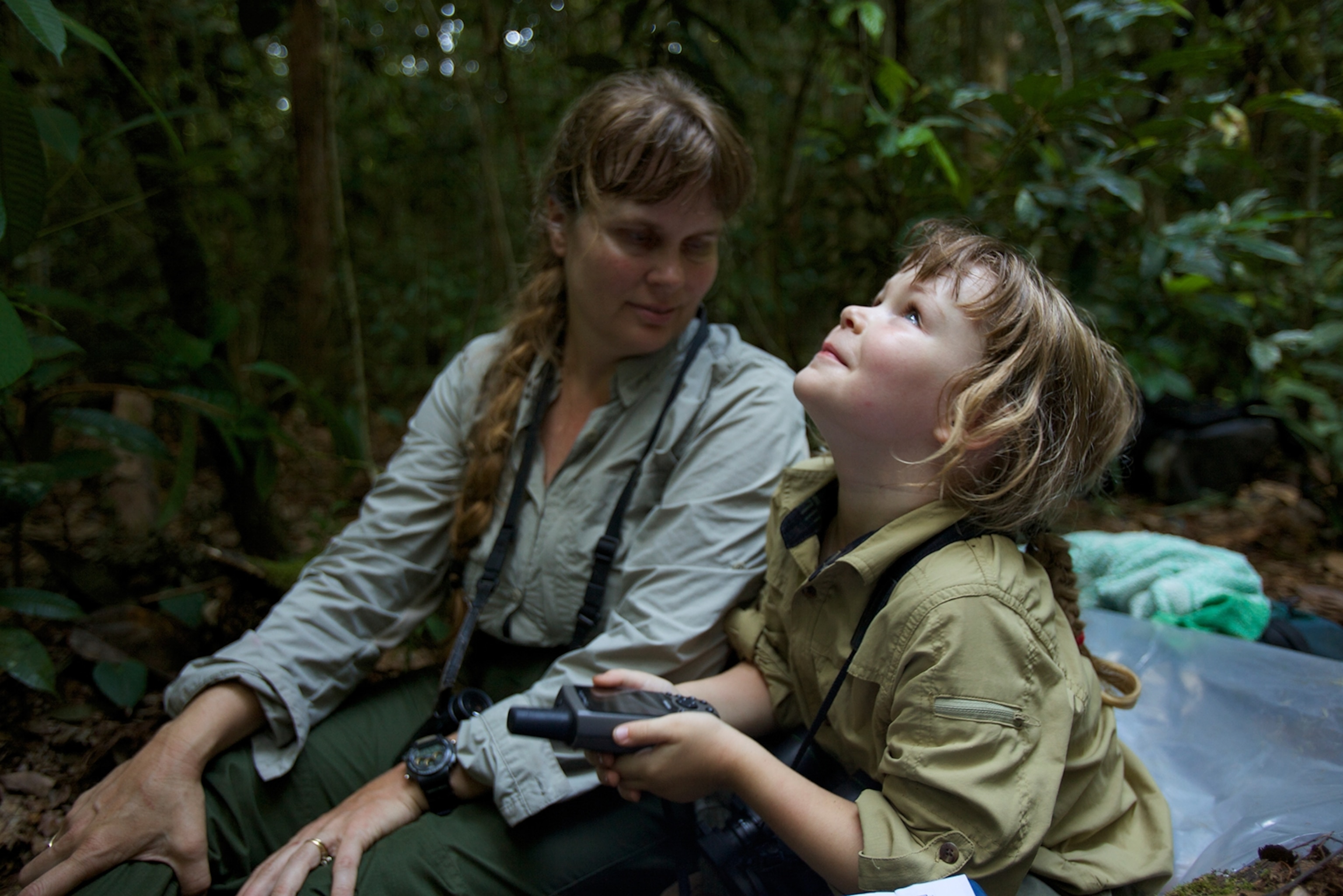 Jessica Laman plays with her mother, orangutan researcher Cheryl Knott's GPS unit.