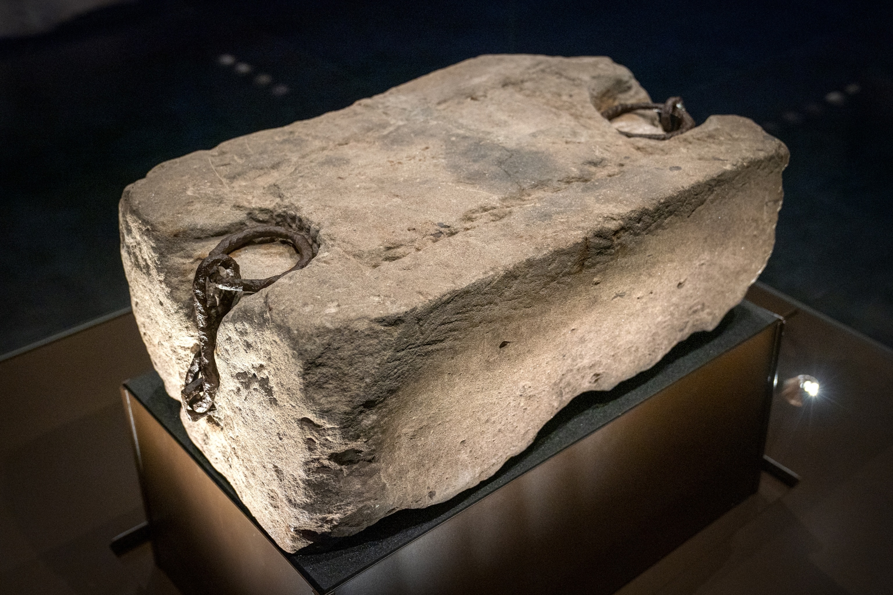 A rectangular stone slab sits on a stand