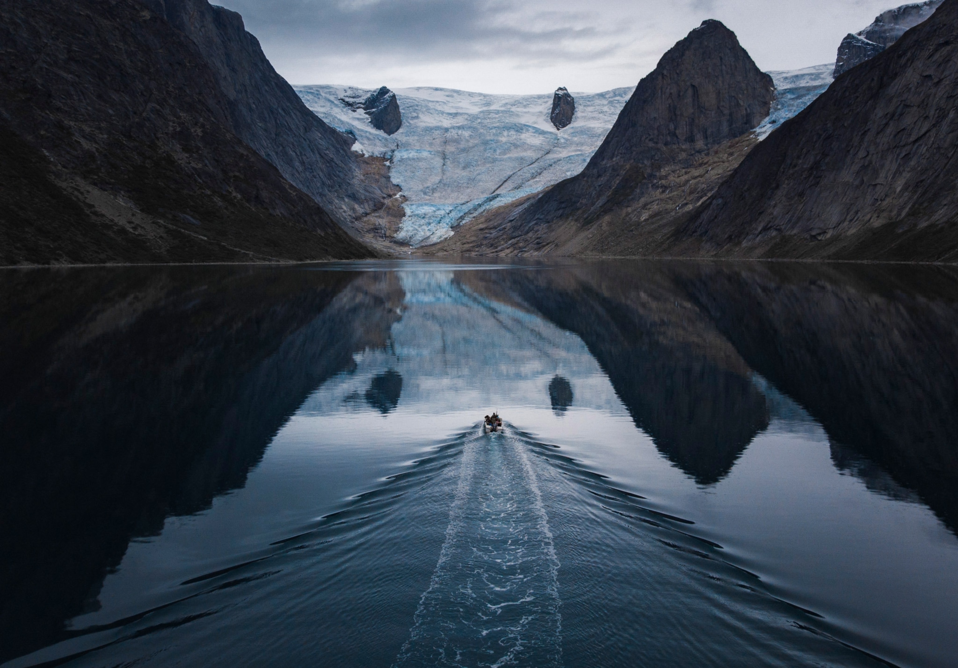 a boat on the water in Tasermiut Fjord, Greenland
