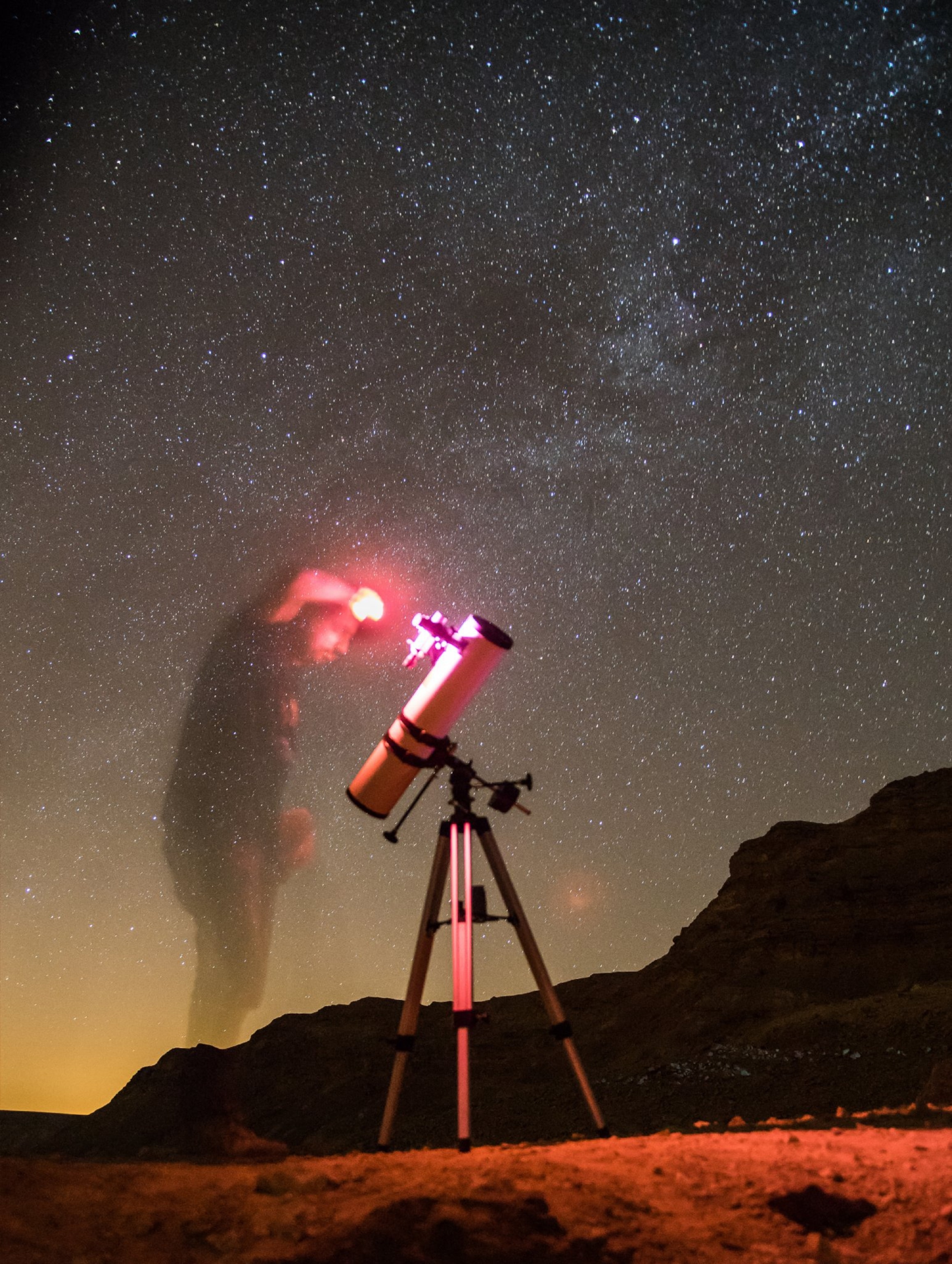 a man at a telescope.