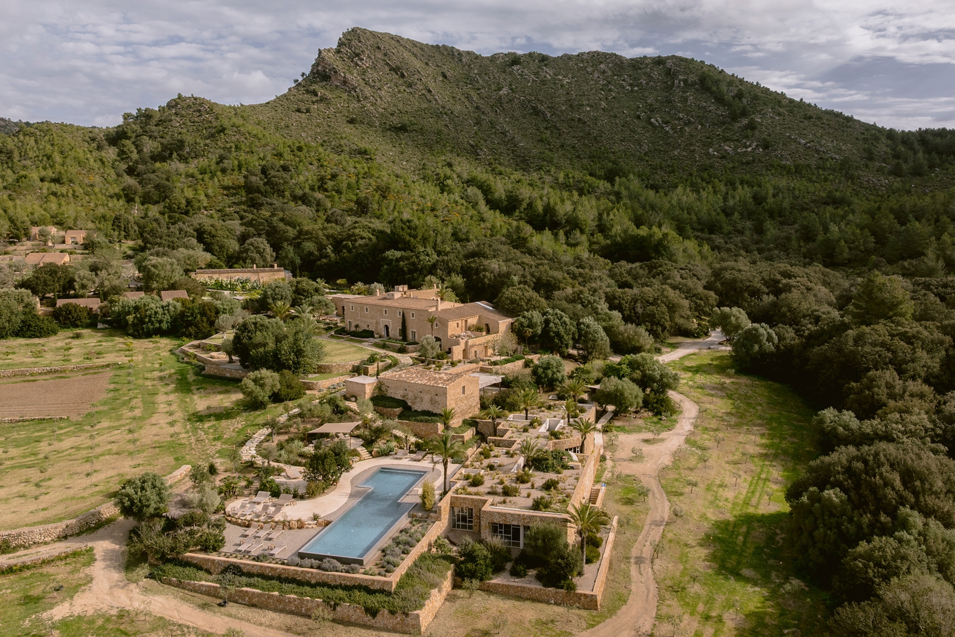 an aerial view of a hotel in the mountains