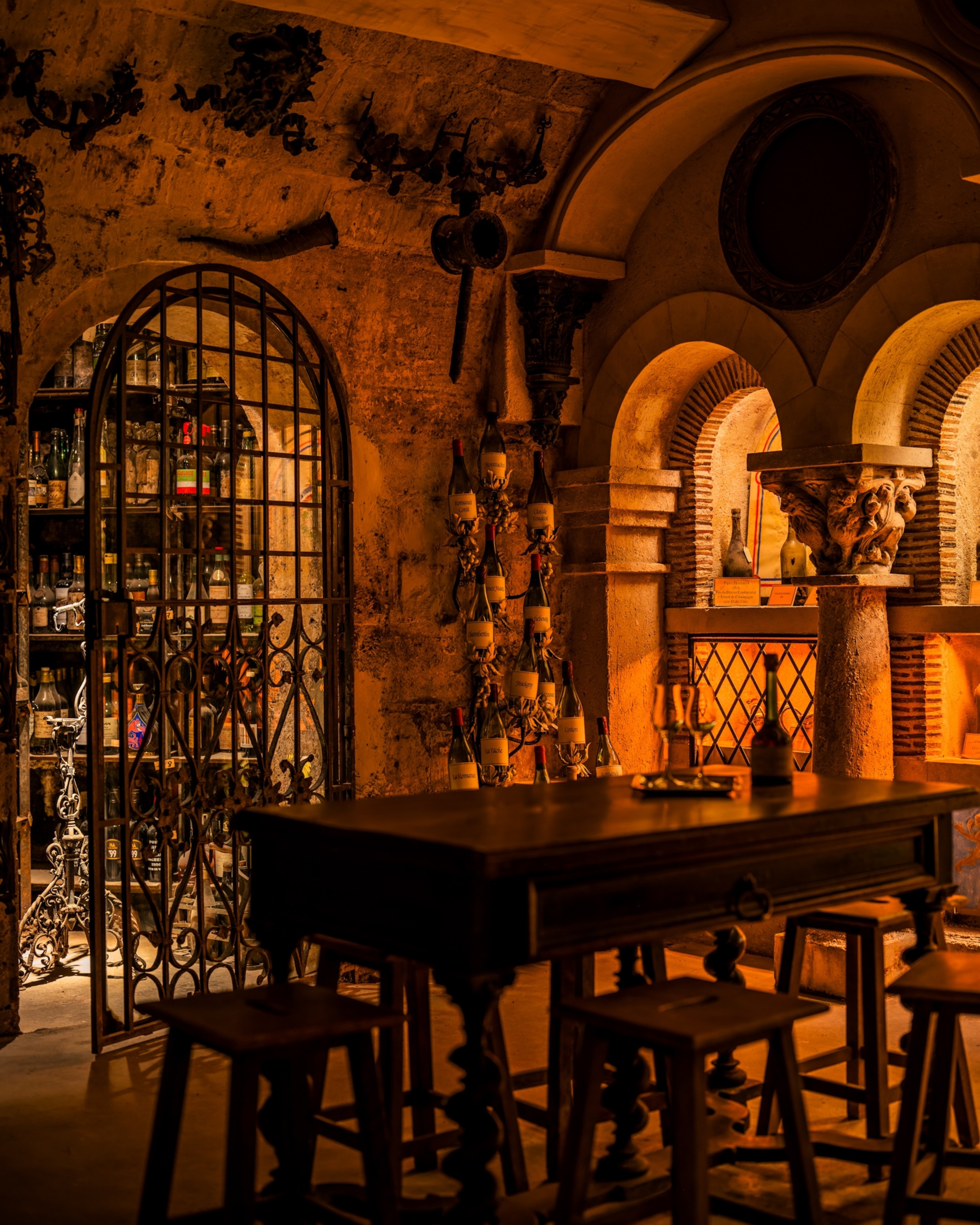 A table in a warmly lit room. The room is in a wine cellar in the Tour d'Argent hotel in Paris, France.