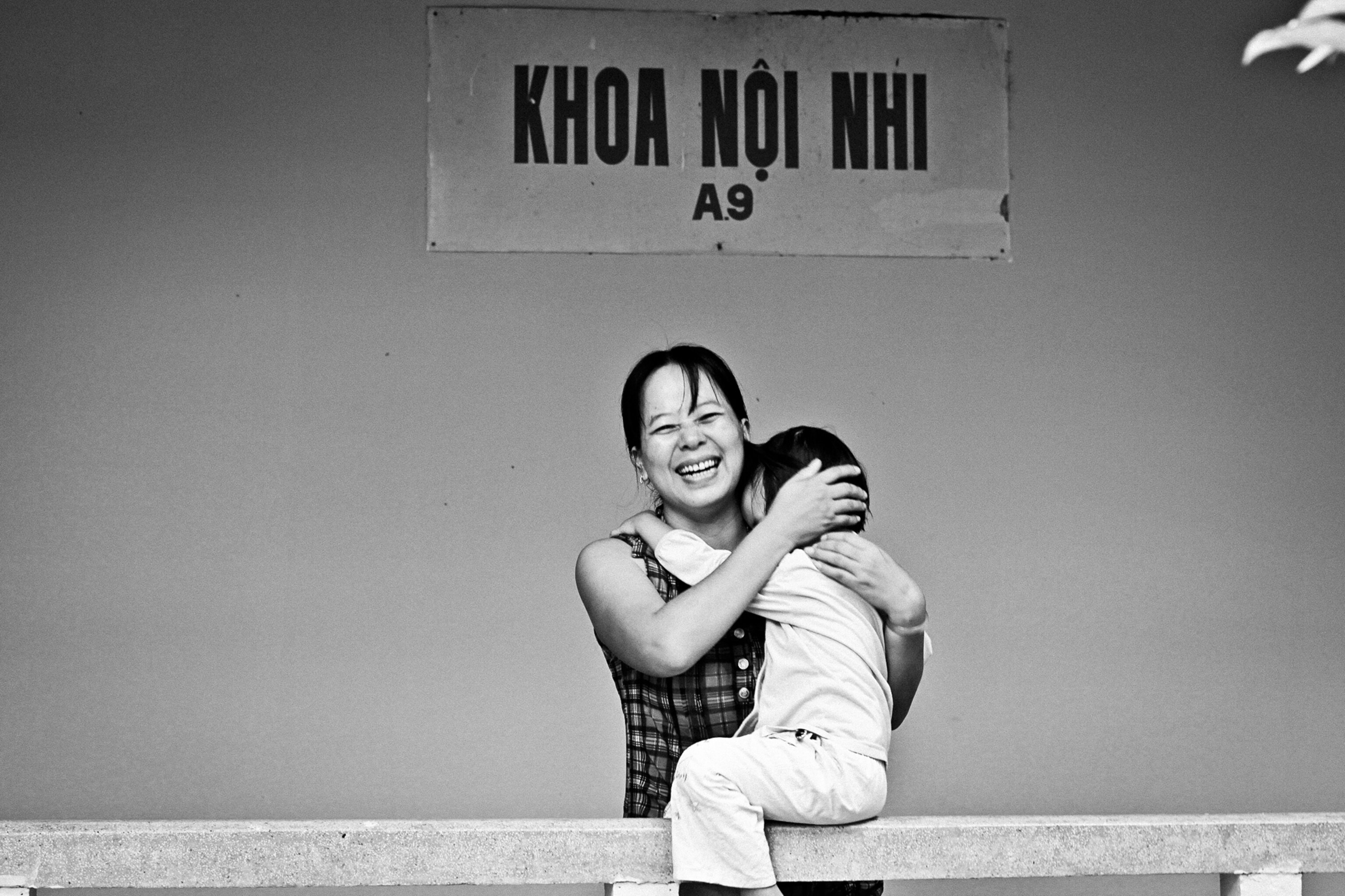 a smiling mother and son in a hospital