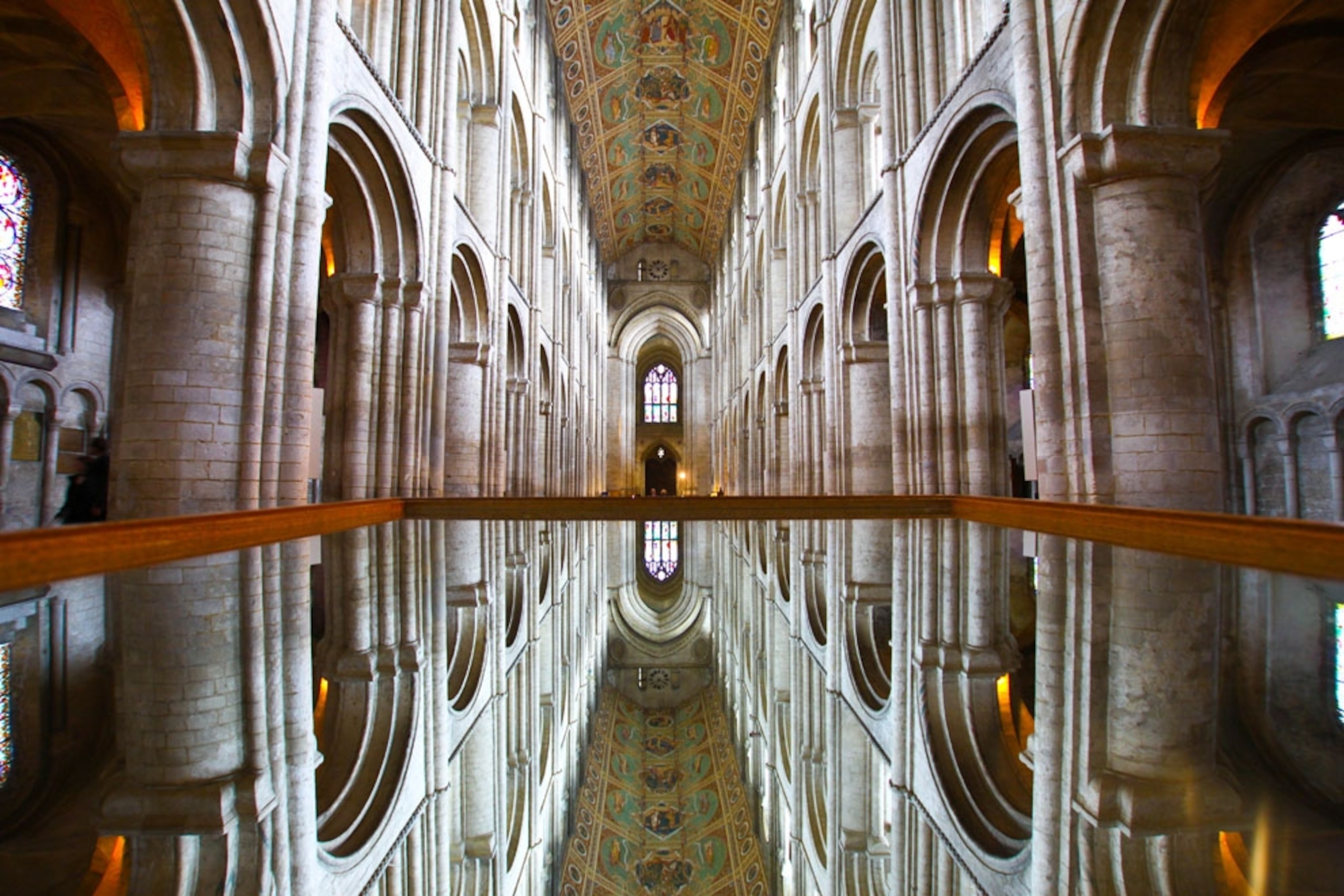 The inside of Ely Cathedral, reflected in a pool of water