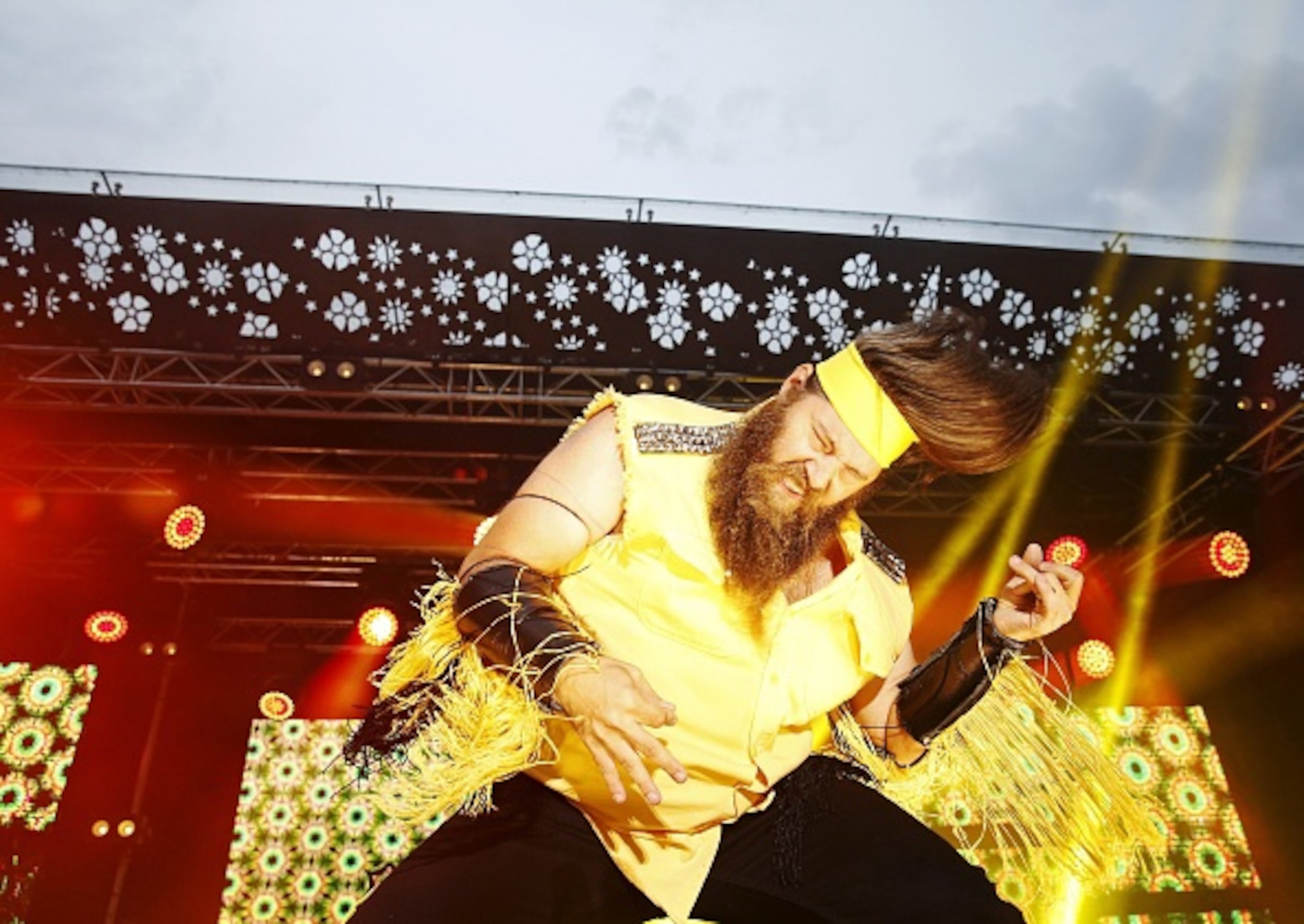 A man swings his hair around in a circle.