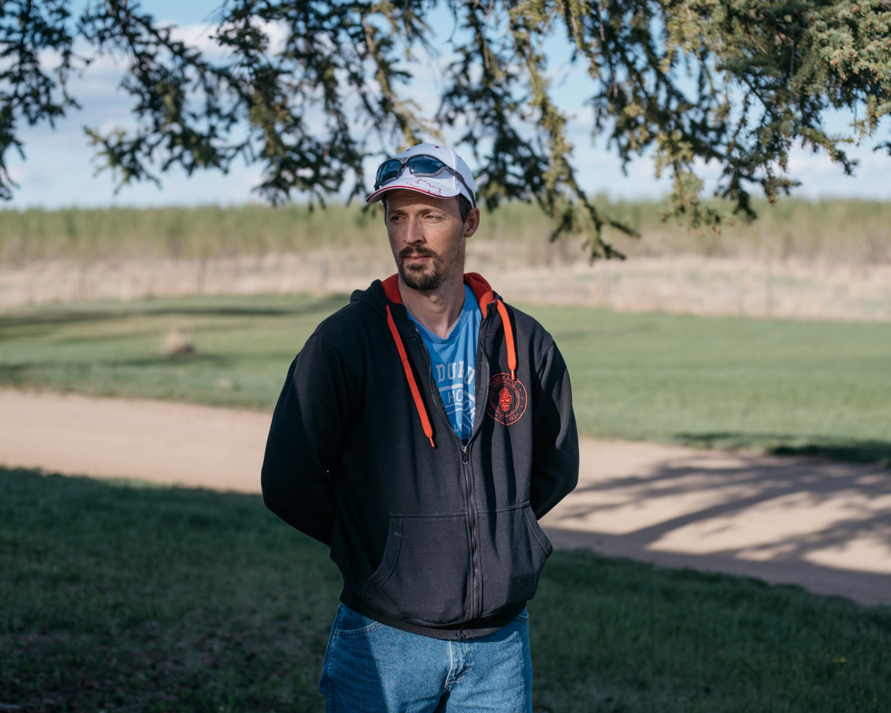 a man standing under a tree
