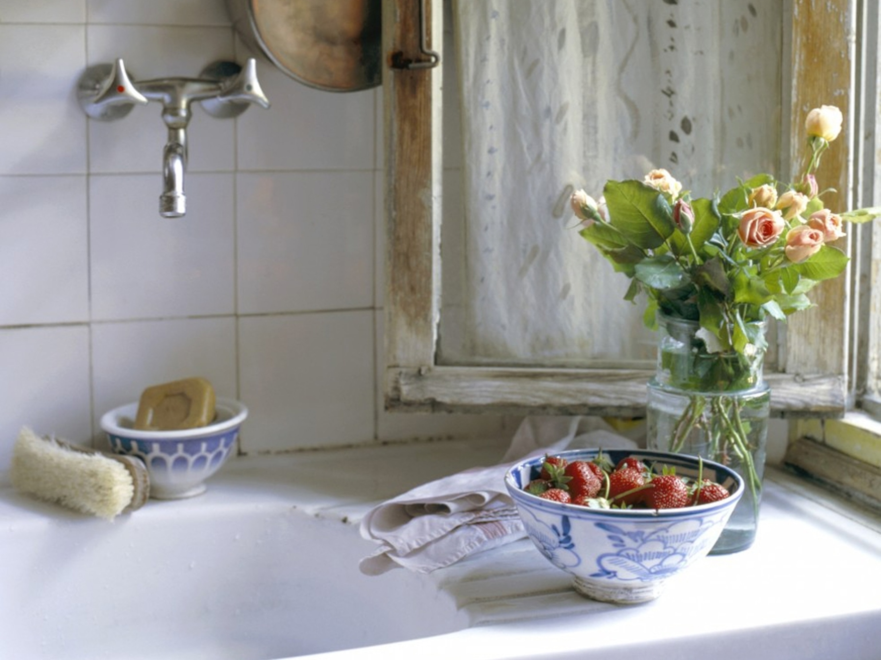 Strawberries and flowers in window