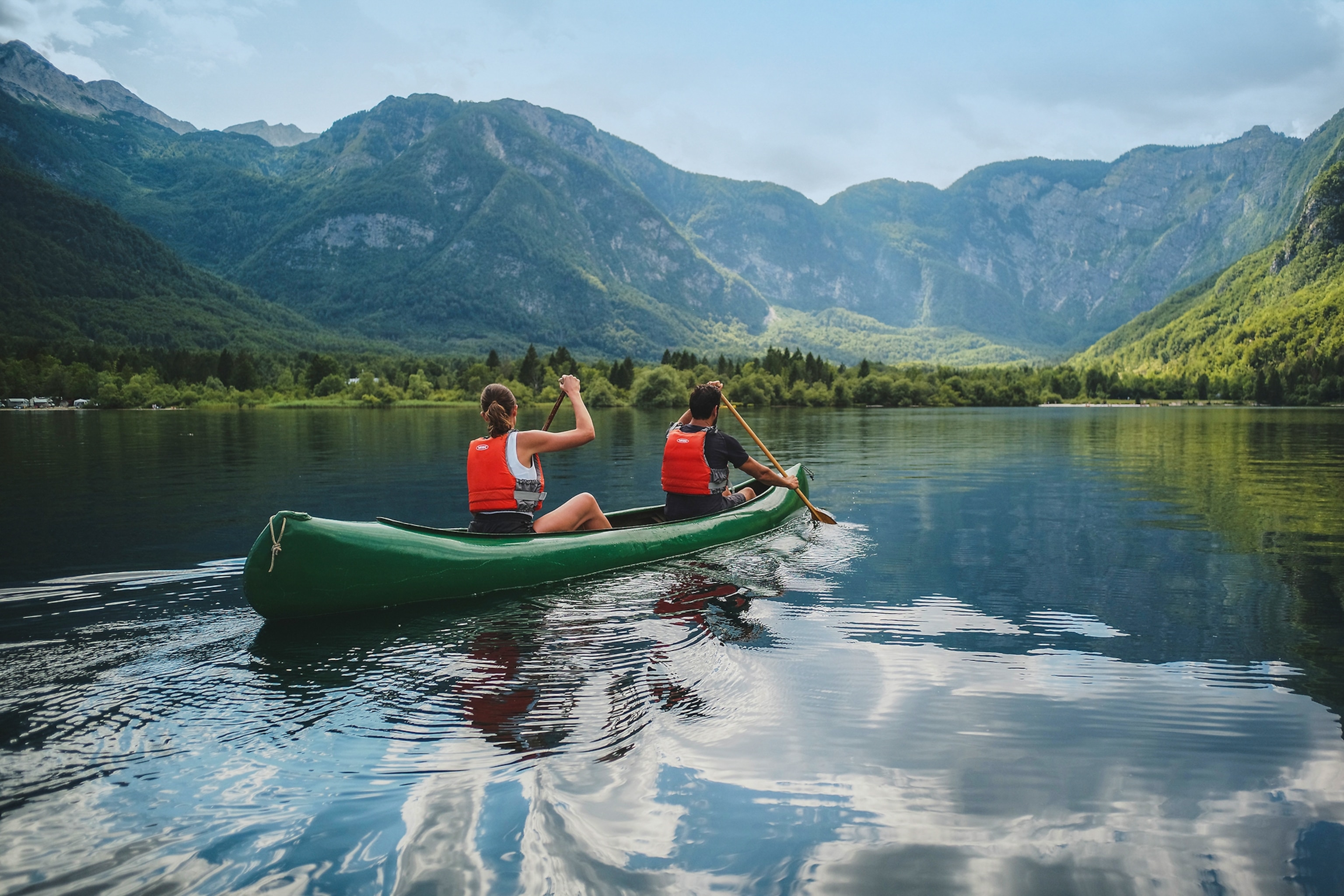 Tourists canoeing on Lake Bohinj.