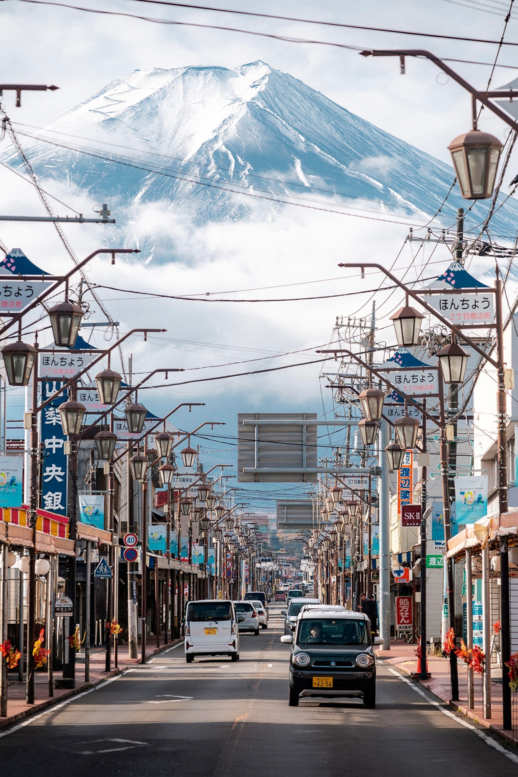 A street view in Japan with Mount Fuji rising up in the distance.