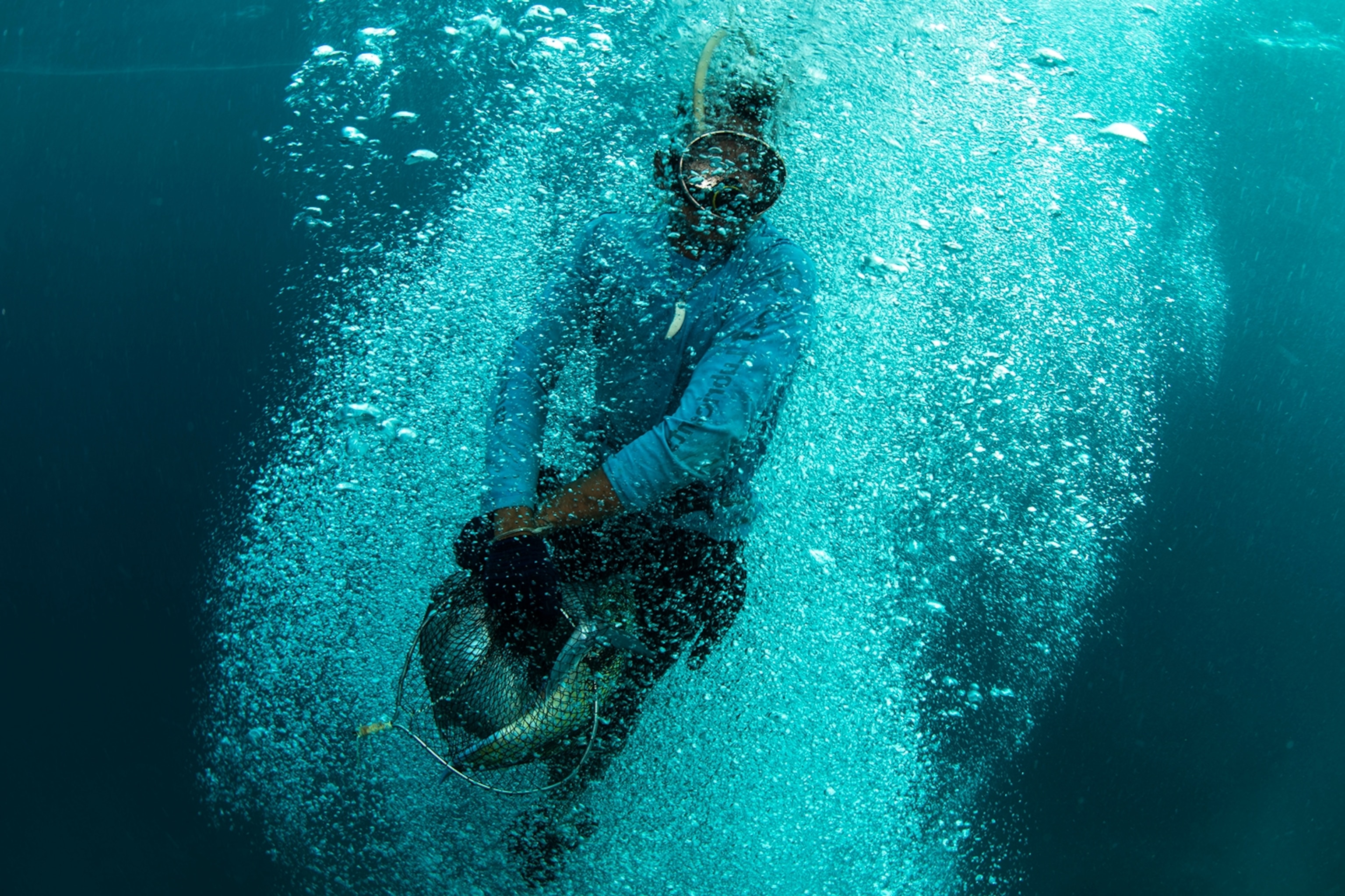 Image of Urak Lawoi fisherman surfacing with his catch.
