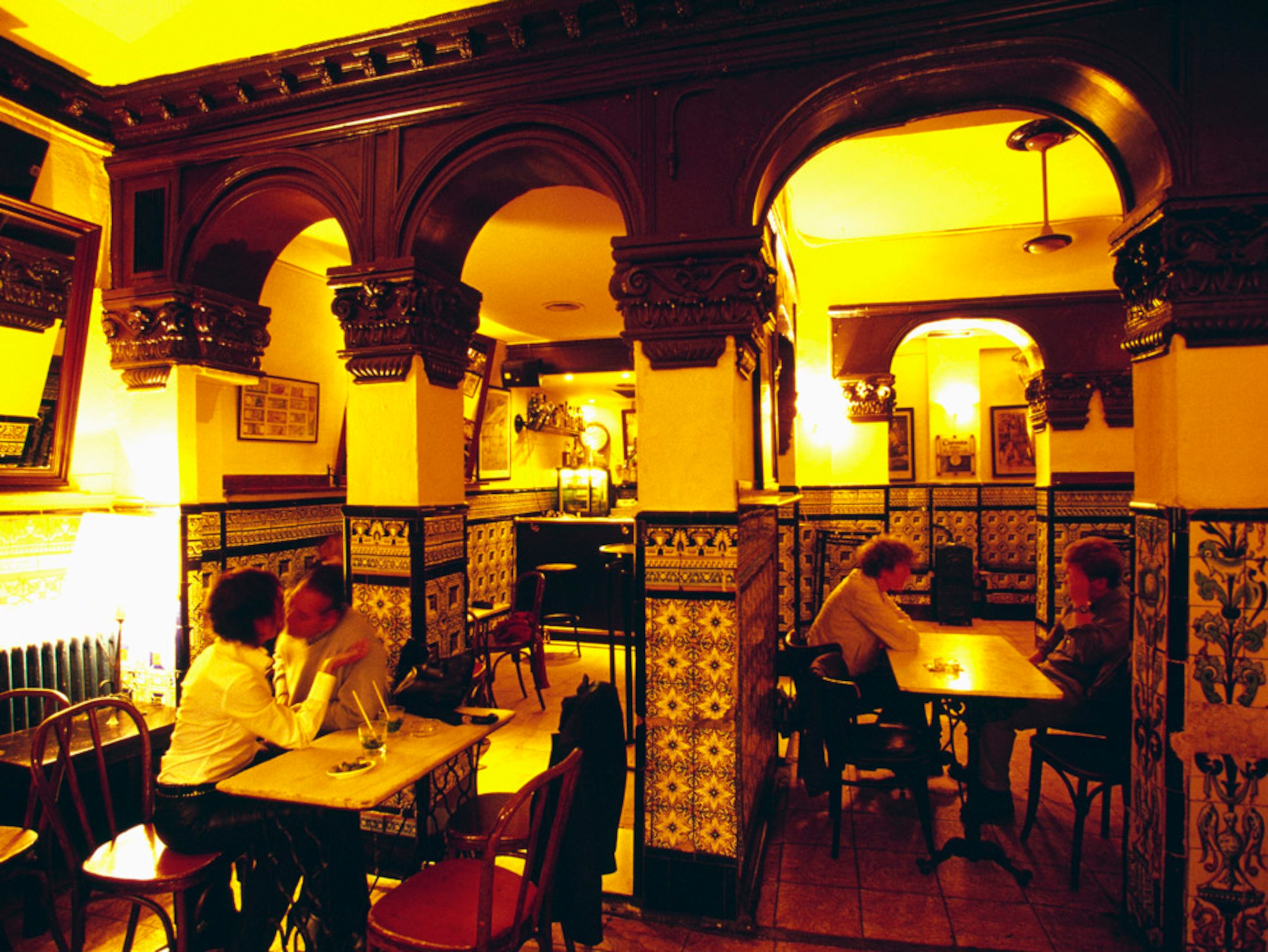 Two couples sitting in a quaint bar