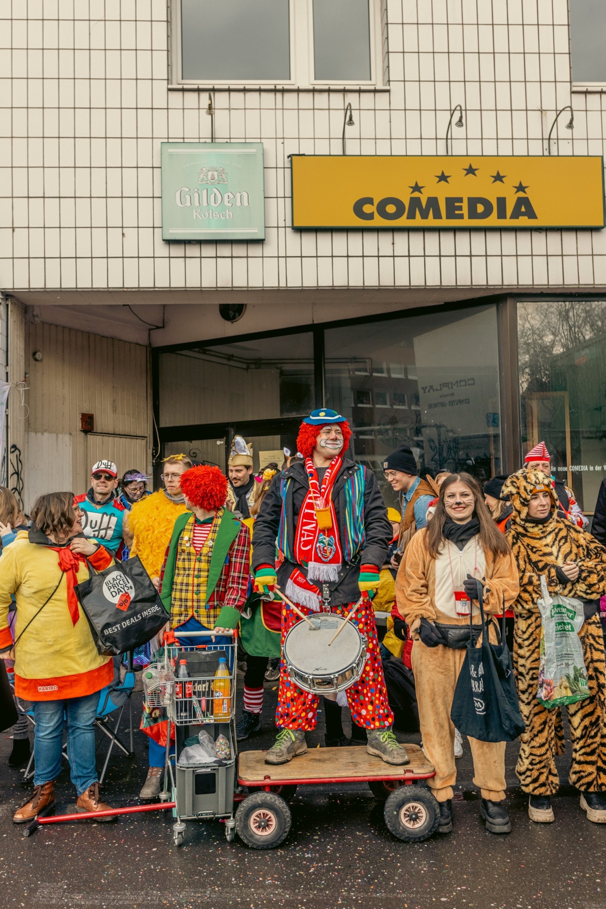 A group of people in costume in front of a building.