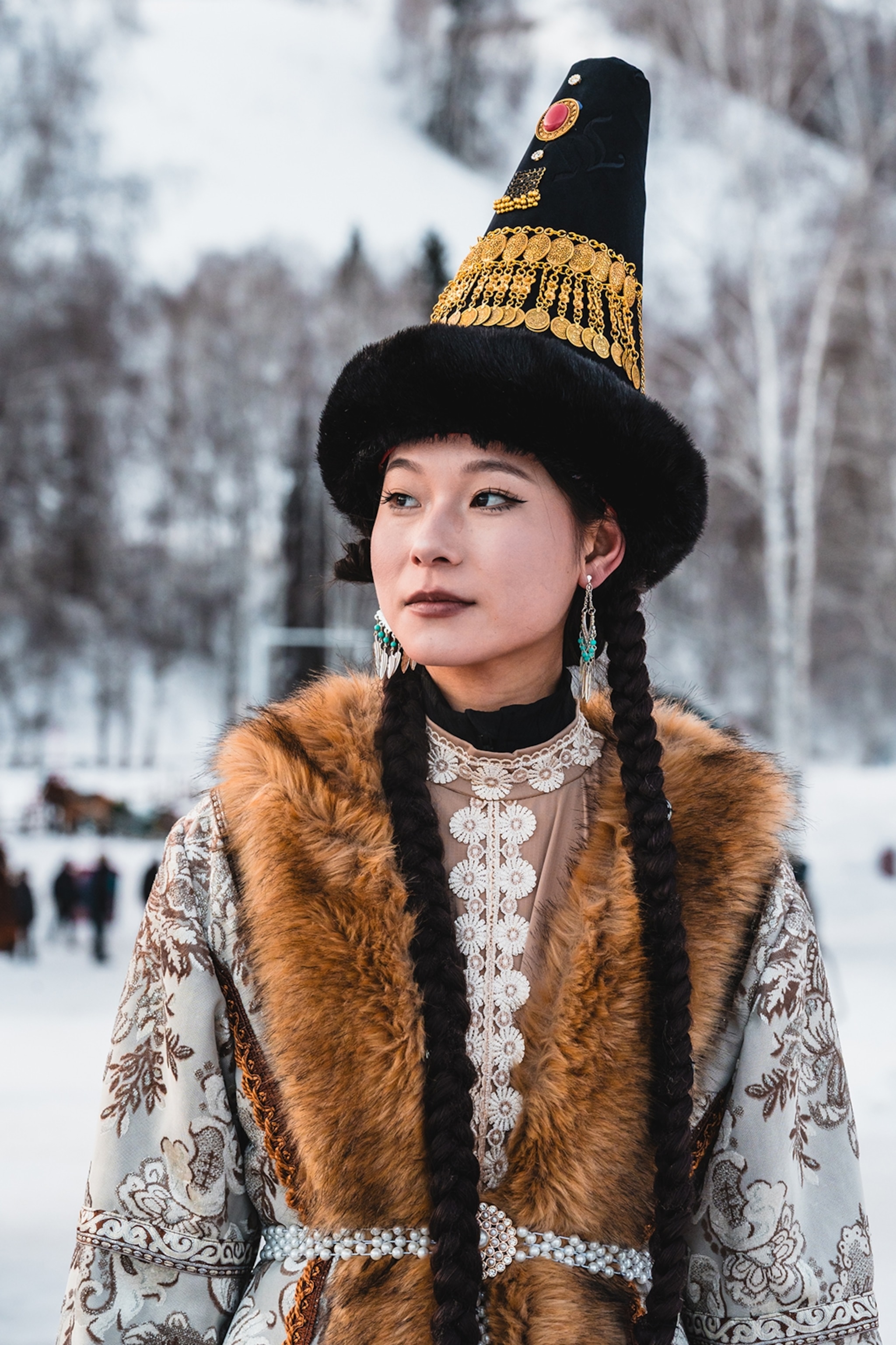 A local woman wearing traditional clothing and a fur vest.
