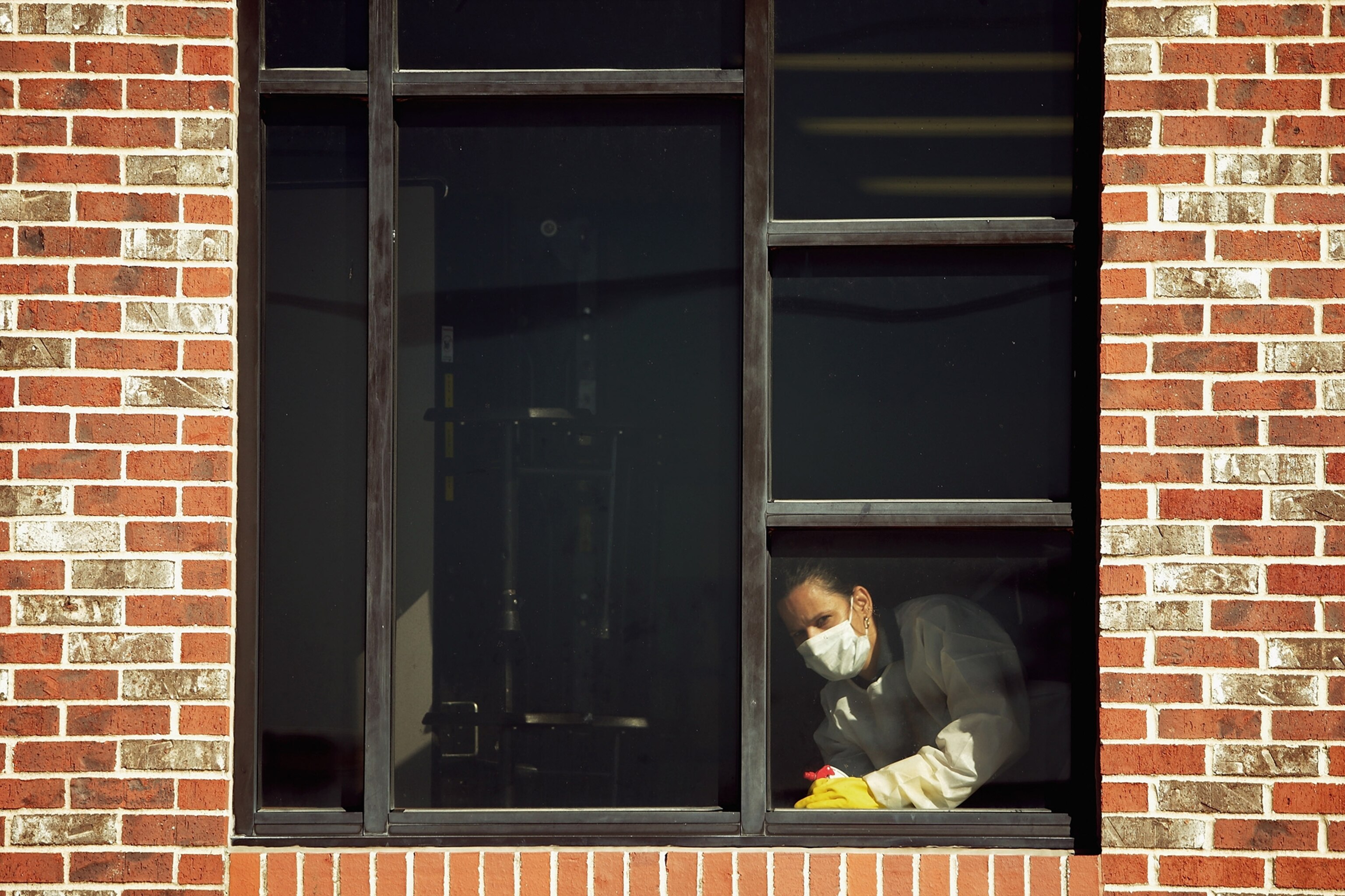 Dr. Steven Hatch, second from right, and colleagues dress into protective clothing before a shift at a clinic run by the International Medical Corps in Suakoko, Liberia, Oct. 12, 2014.