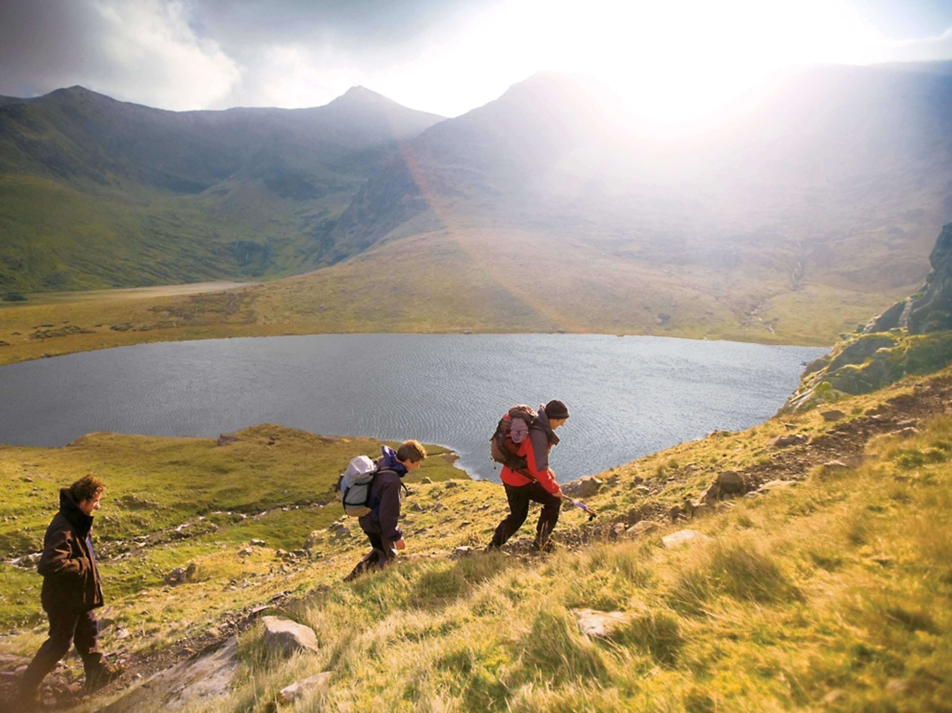 hikers exploring Carrauntoohill, the tallest peak in Ireland.