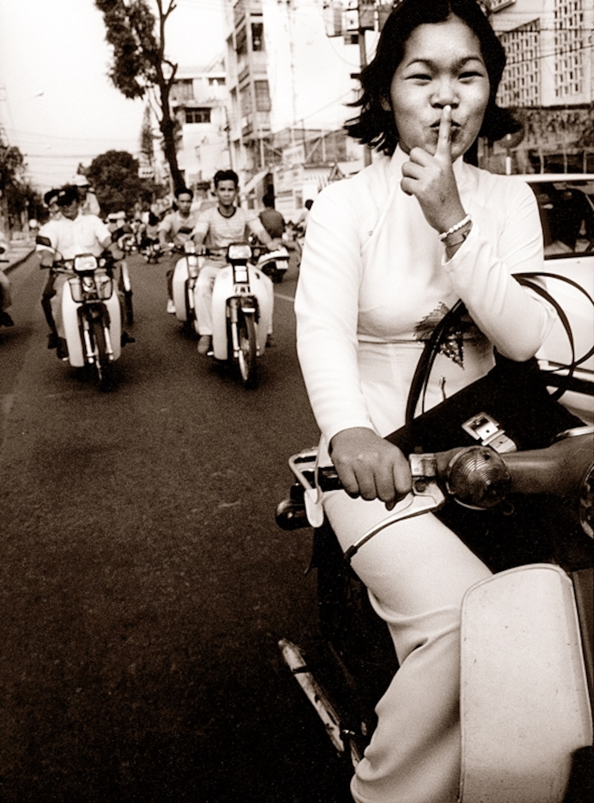a woman riding a motorbike in Saigon, Vietnam