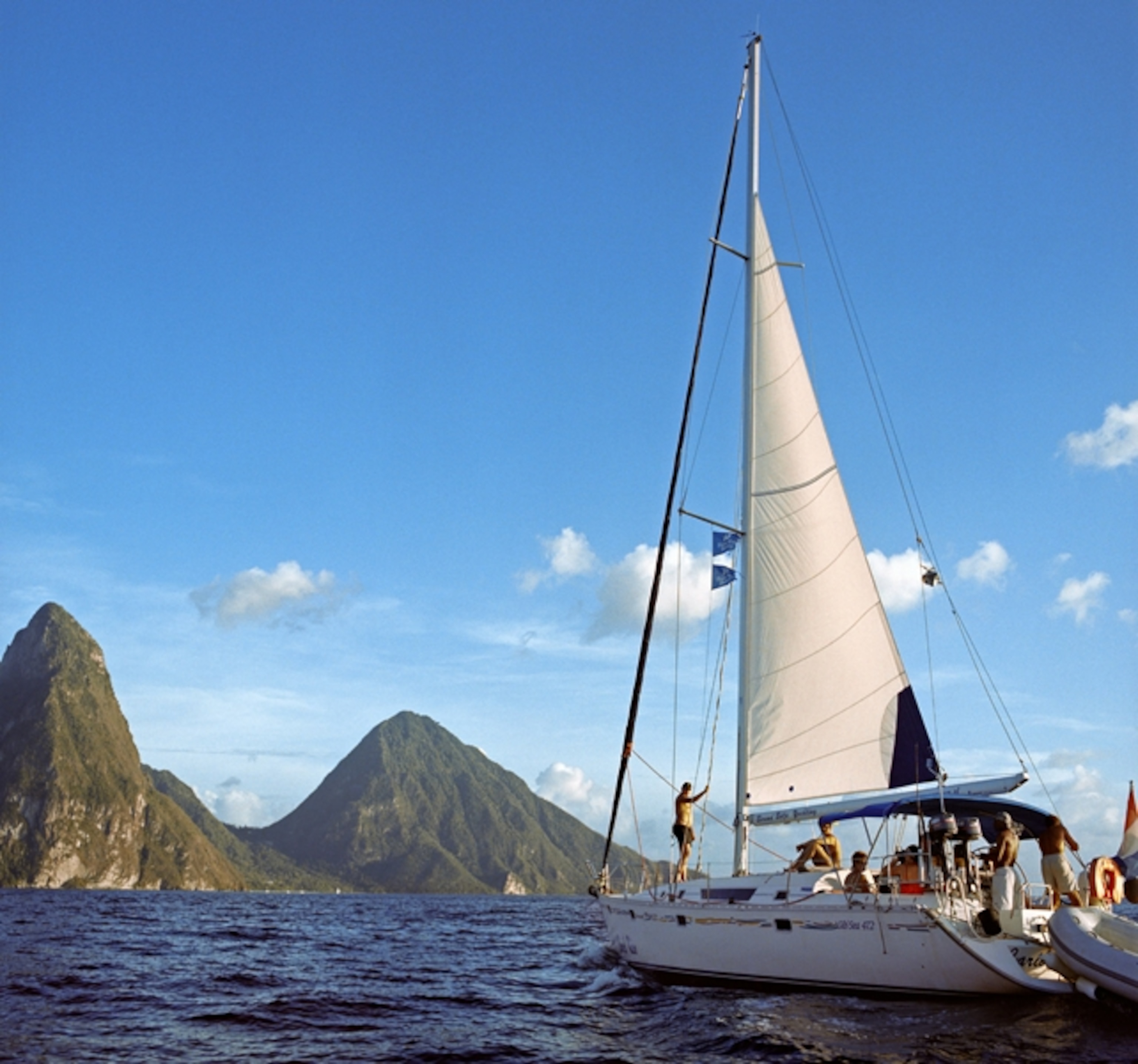 Sailboat in front of green mountains