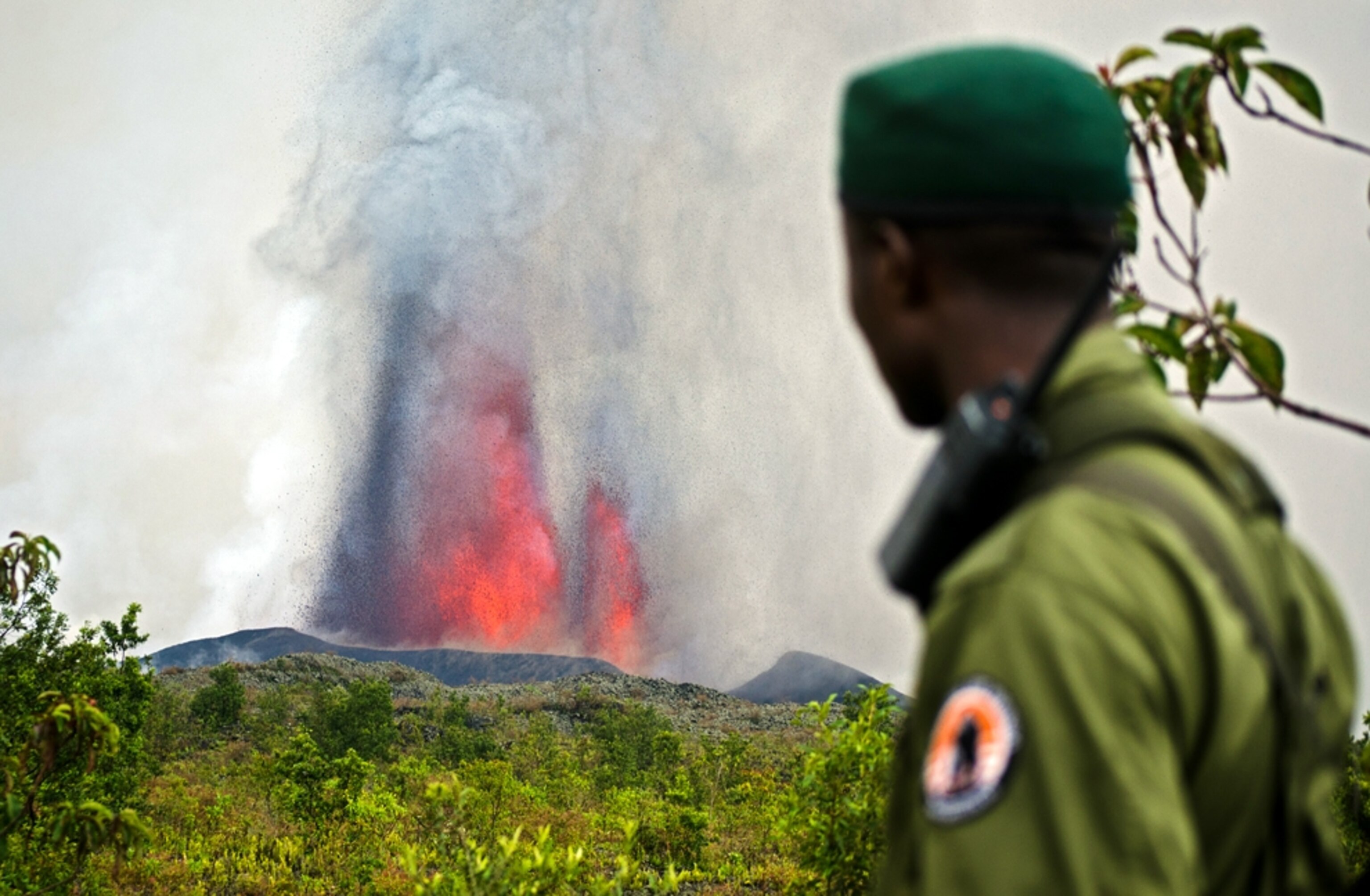 Nyamulagira volcano picture: An armed officer stands near the site of the Virunga National Park volcano eruption, for a gallery on camping at the Virunga volcano eruption