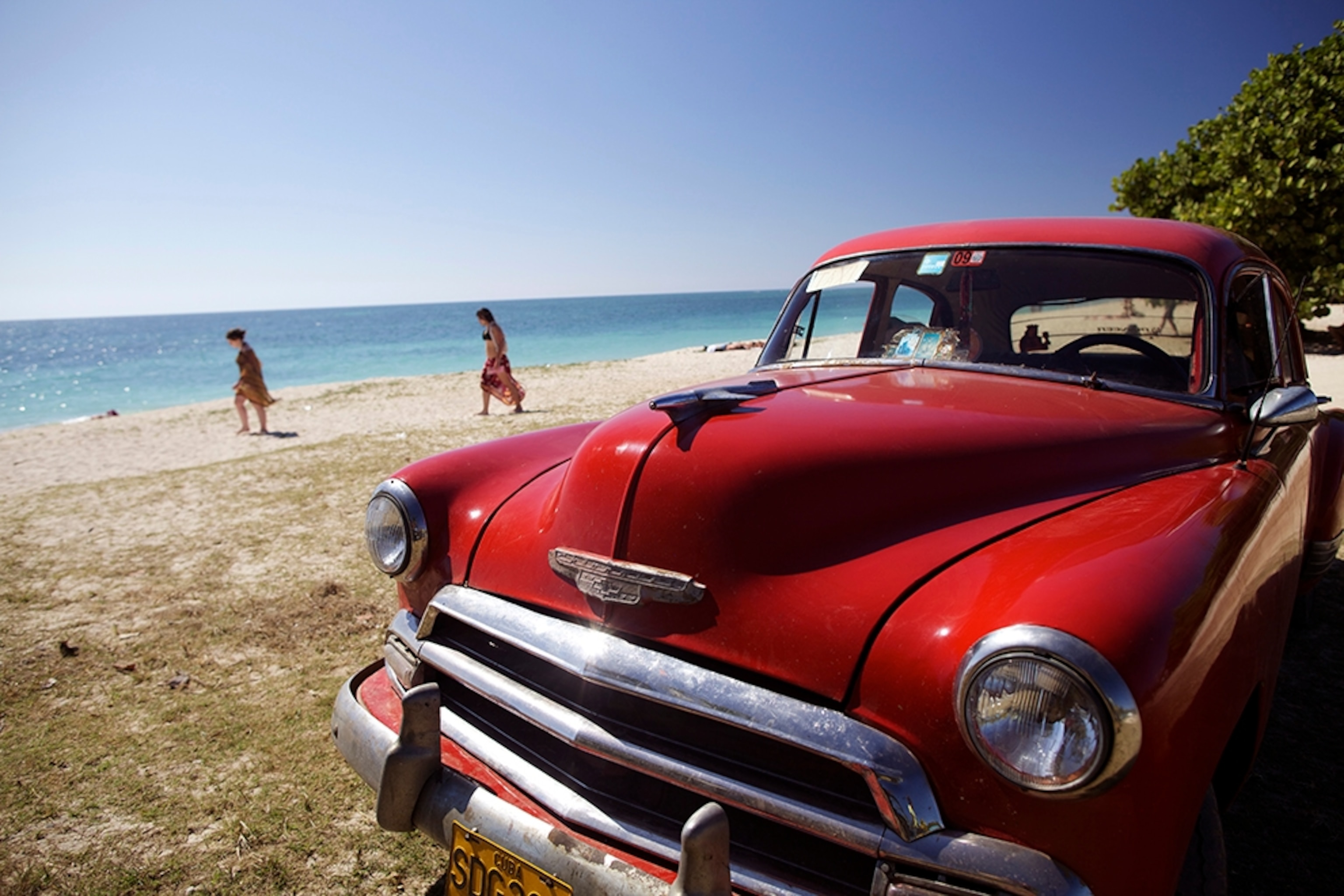 a car on Playa Ancon beach, Cuba