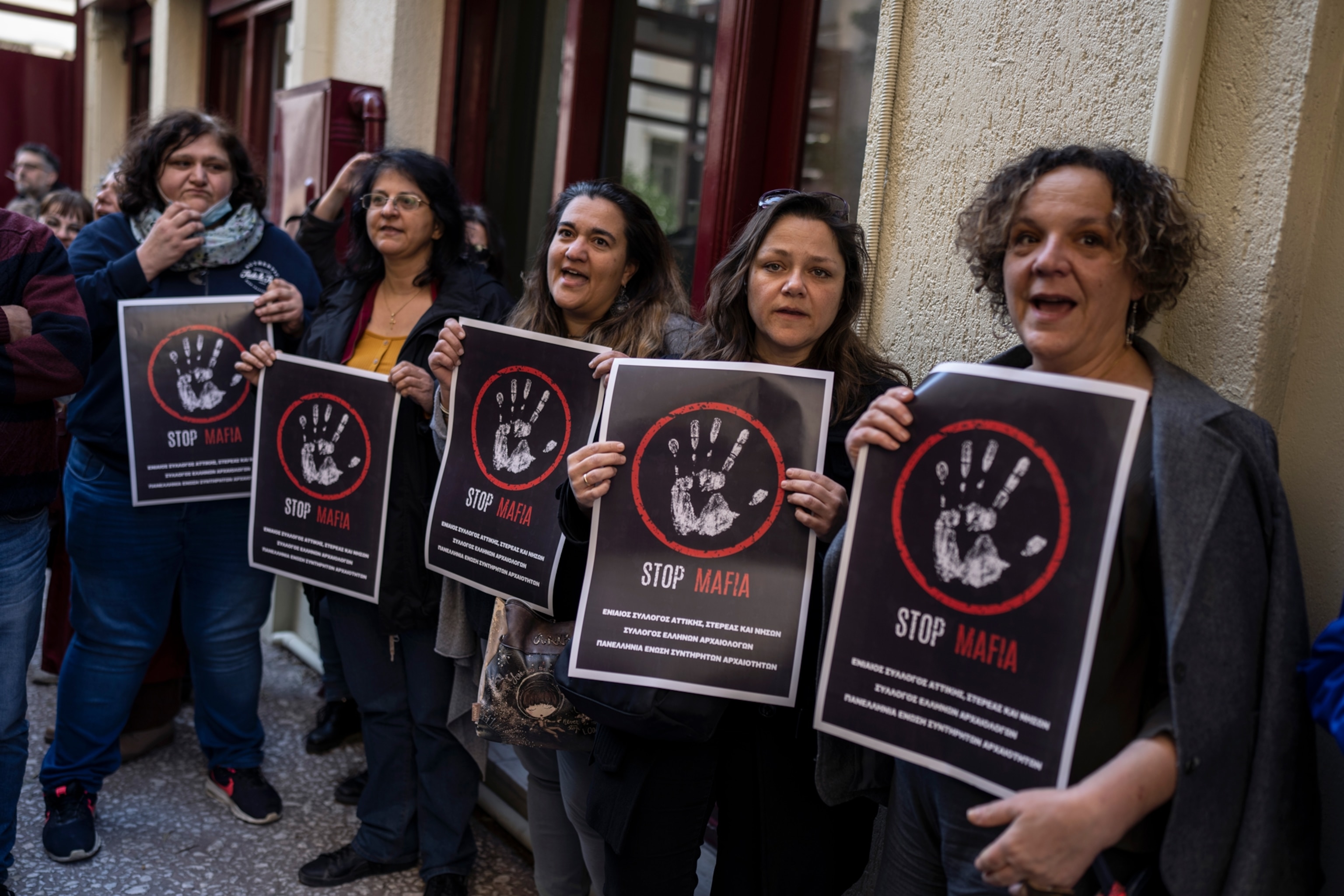 State-employed archaeologists in Greece hold placards as they launched strike action outside the Culture Ministry in Athens