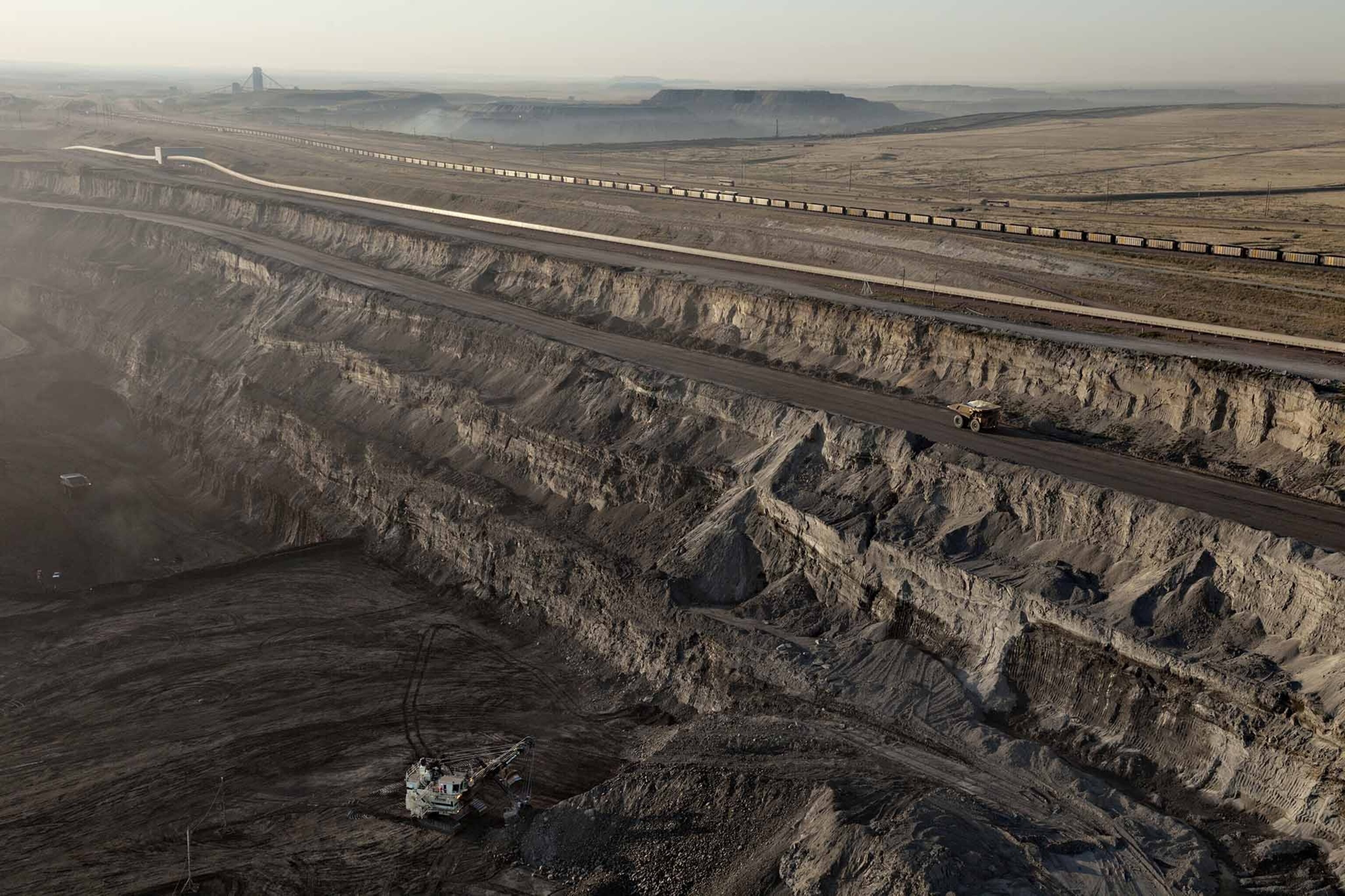 The Black Thunder min, one of the world's largest, covers 75 square miles of public and private land. Trucks the size of houses haul more than 90 million tons of coal a year to trains, which carry most of it to eastern power plants.