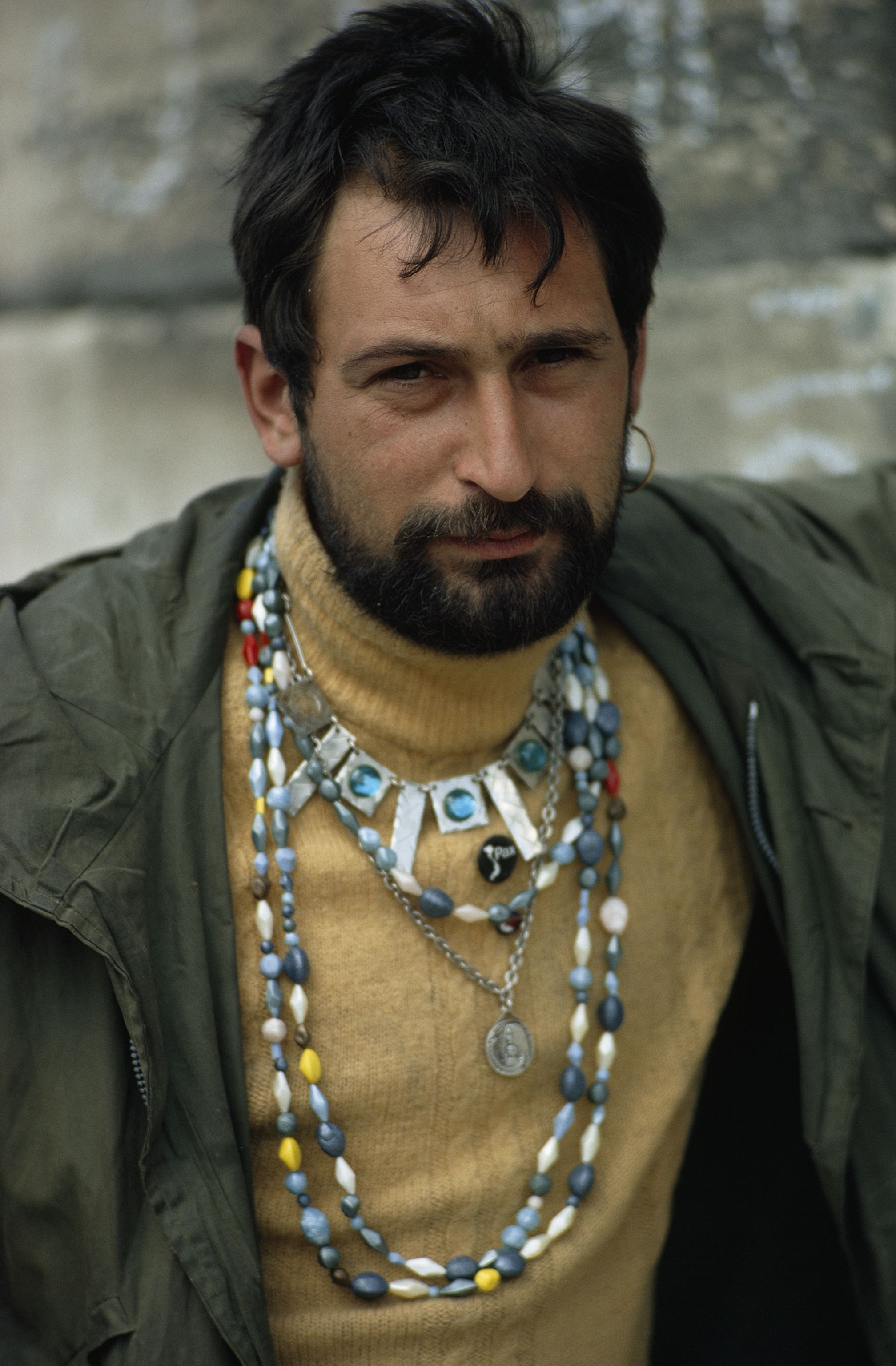 a man wearing necklaces