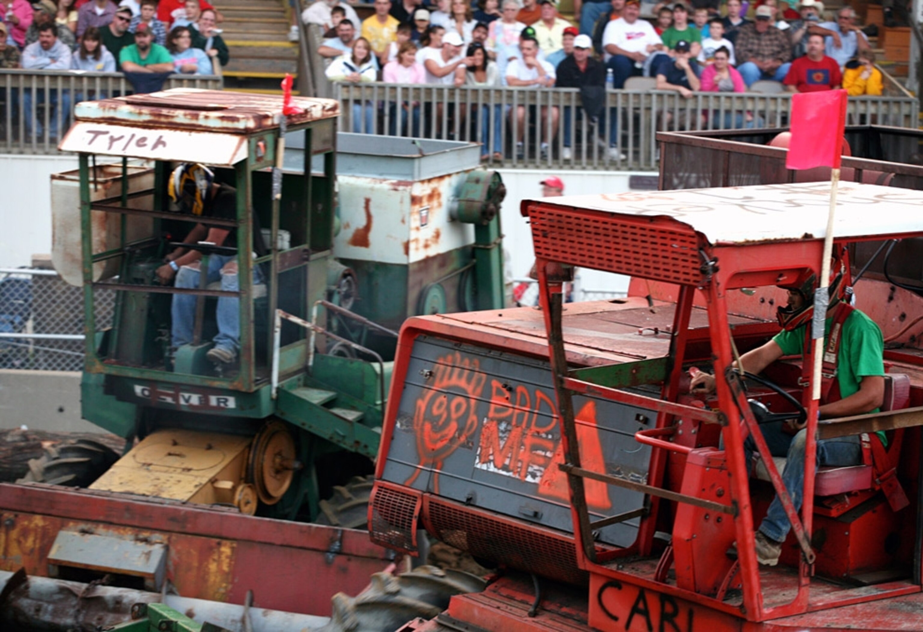 Men in helmets driving combines
