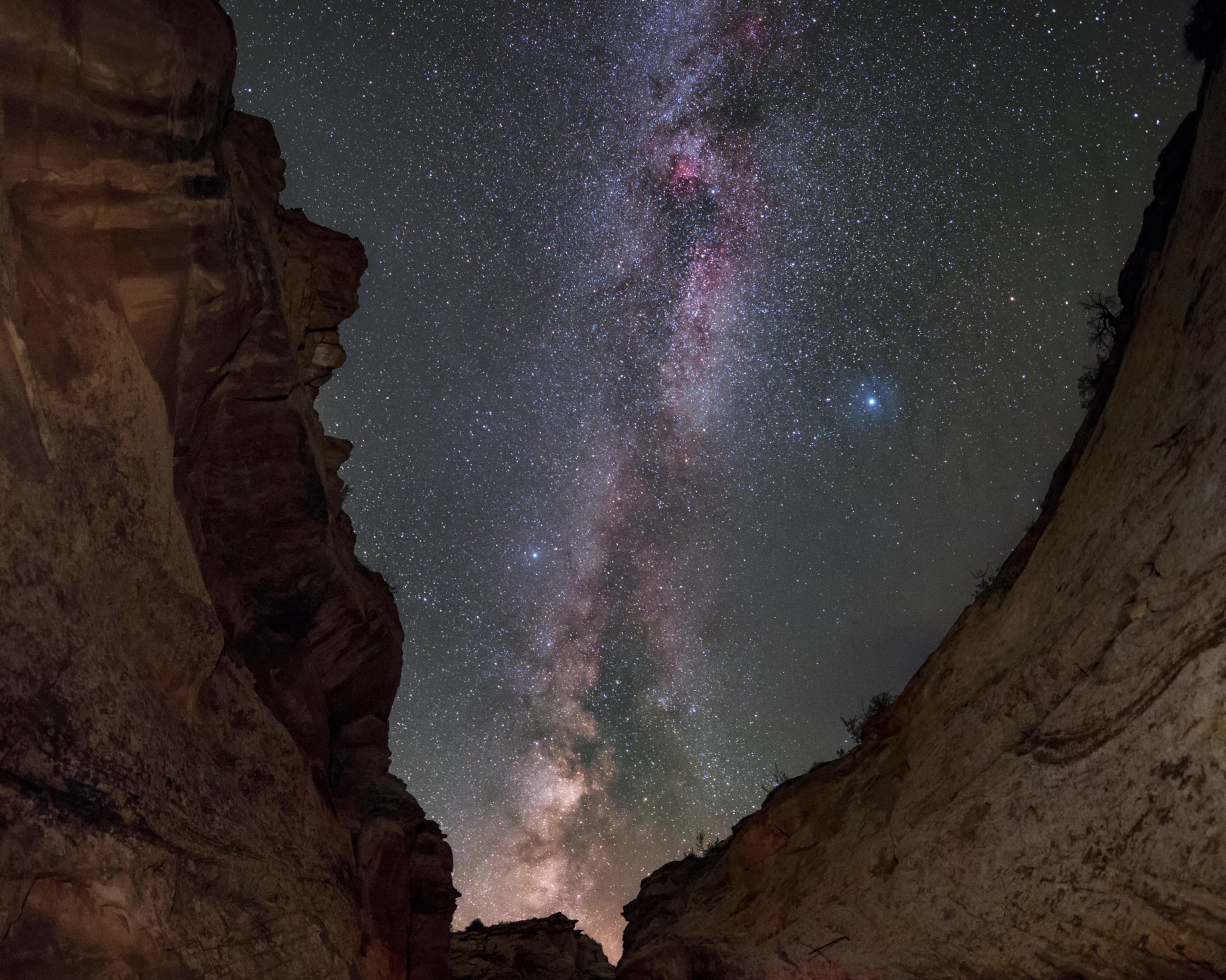 The Milky Way and stars of the Summer Triangle over walls of a gorge.