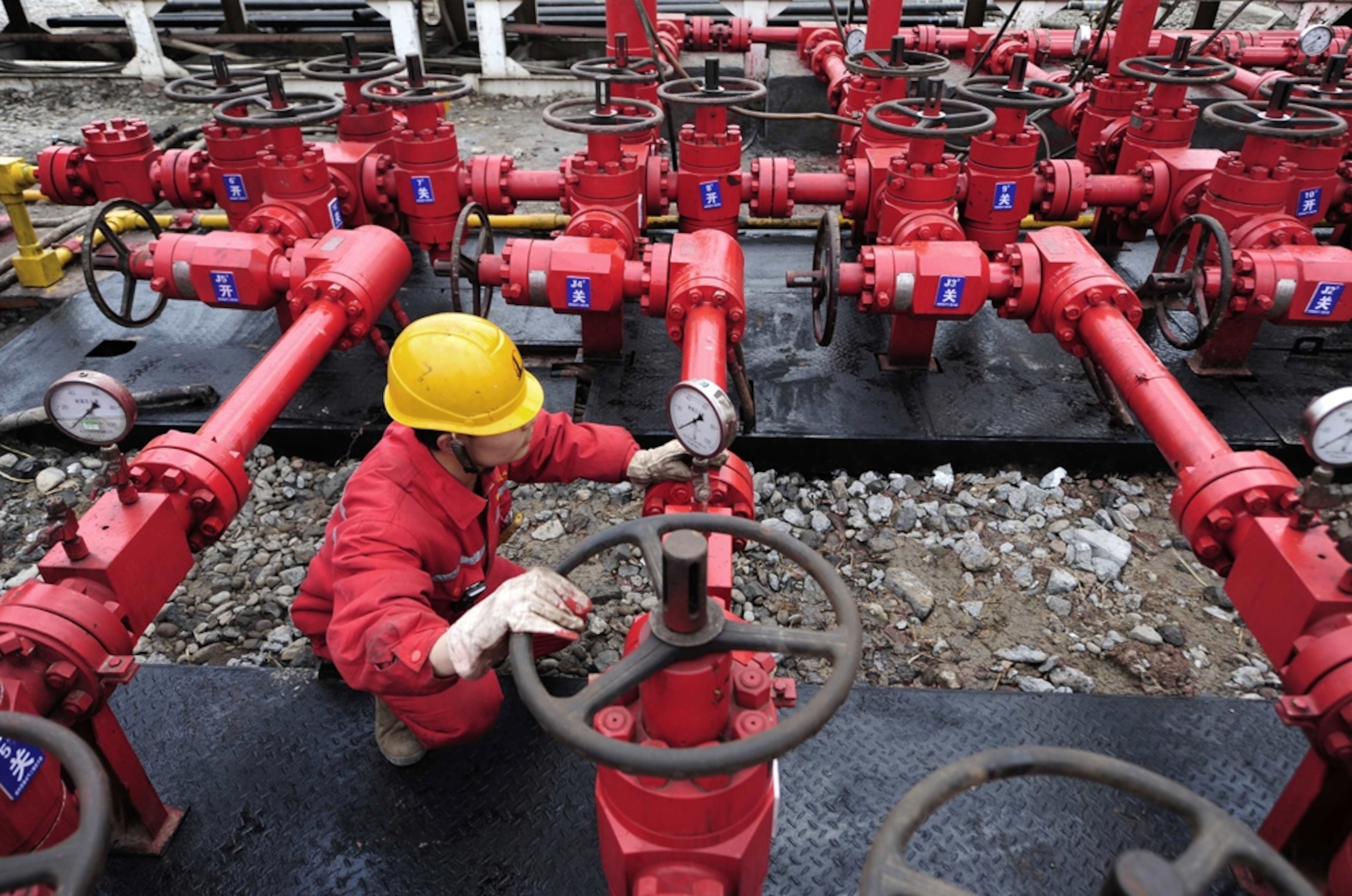 A worker checks a valve at a natural gas field, Sichuan Province, China