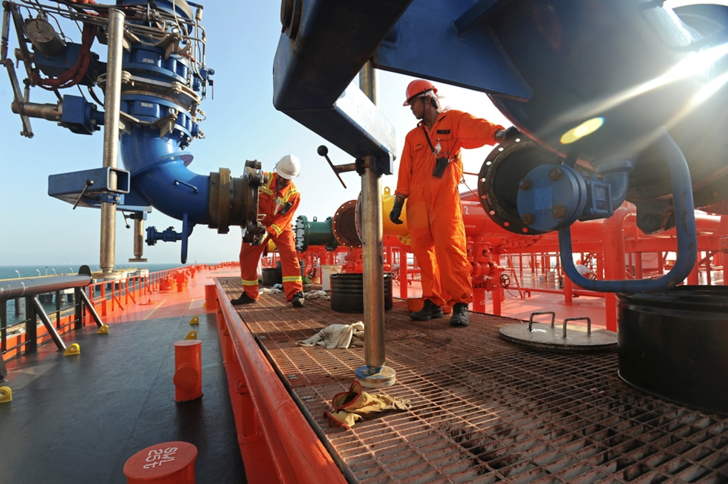 Workers load crude oil from the BTC pipeline onto a tanker at Ceyhan marine terminal