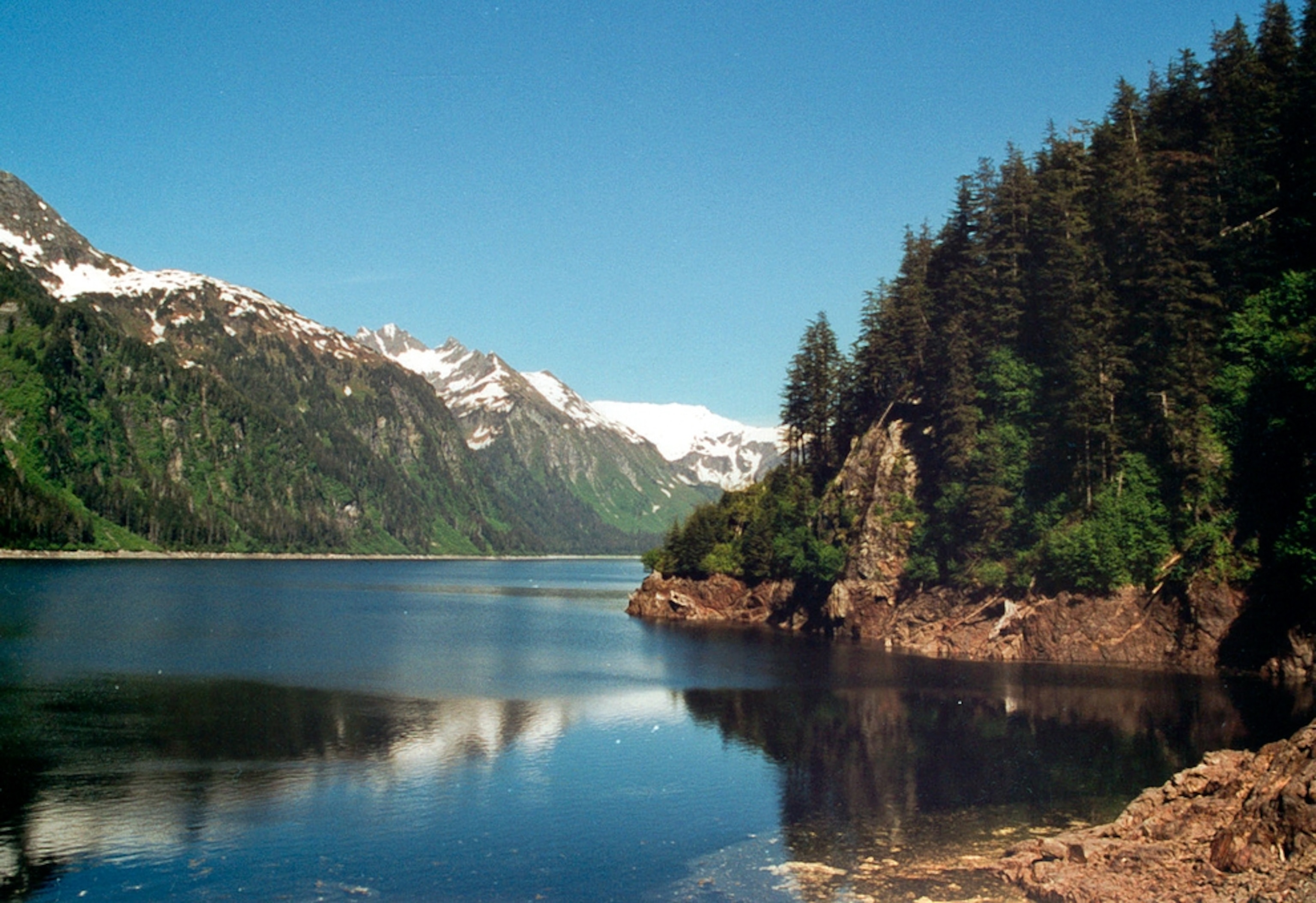 A lake with mountains in the background