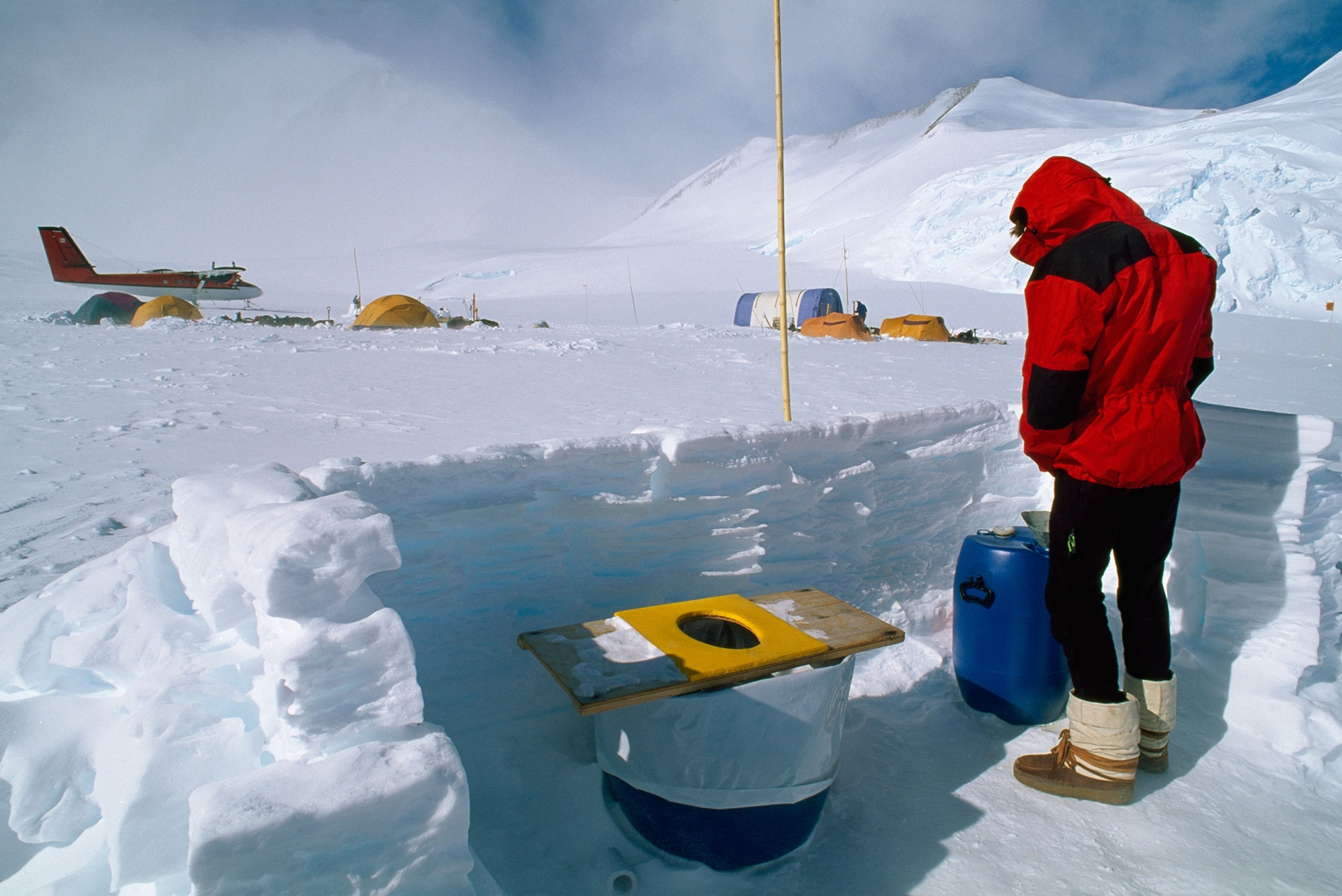 a man using a toilet in Antarctica