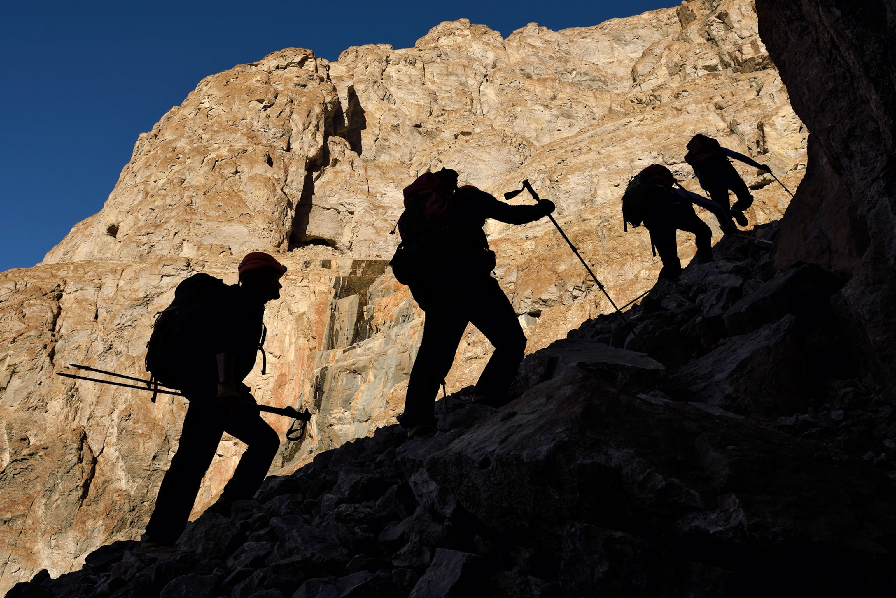 people hiking to caves