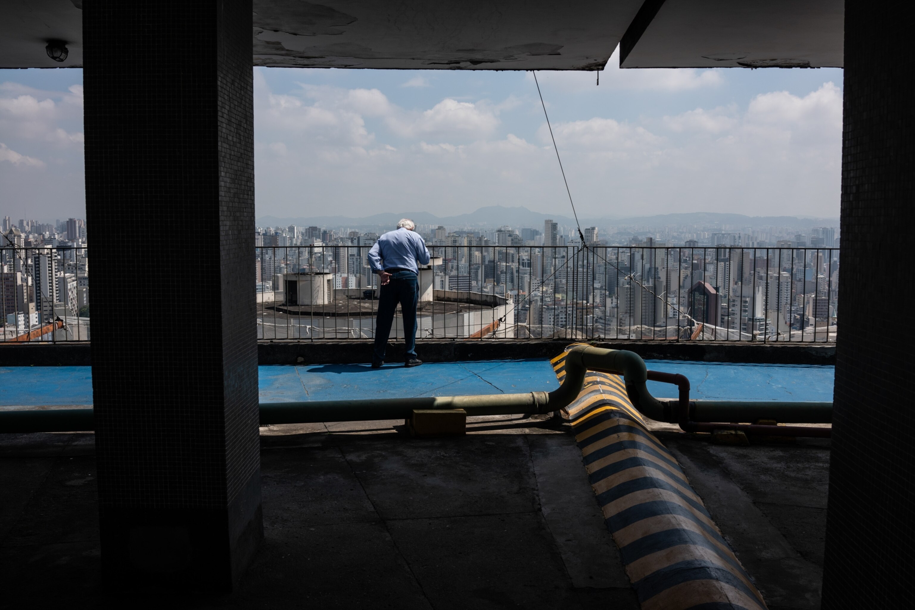 a man looking over the a building on the roof