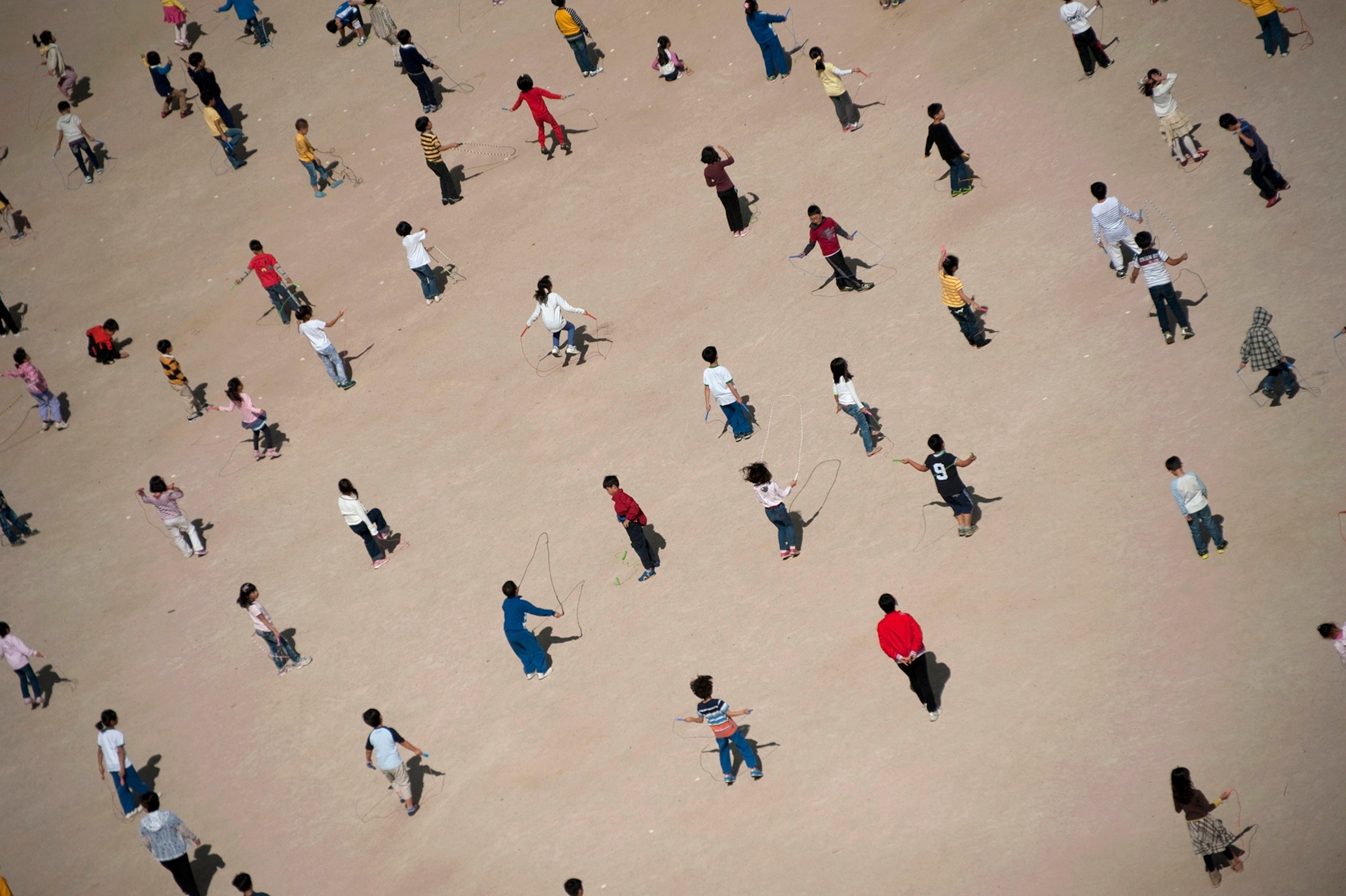Children jumping rope in their school yard in Pusan, South Korea.