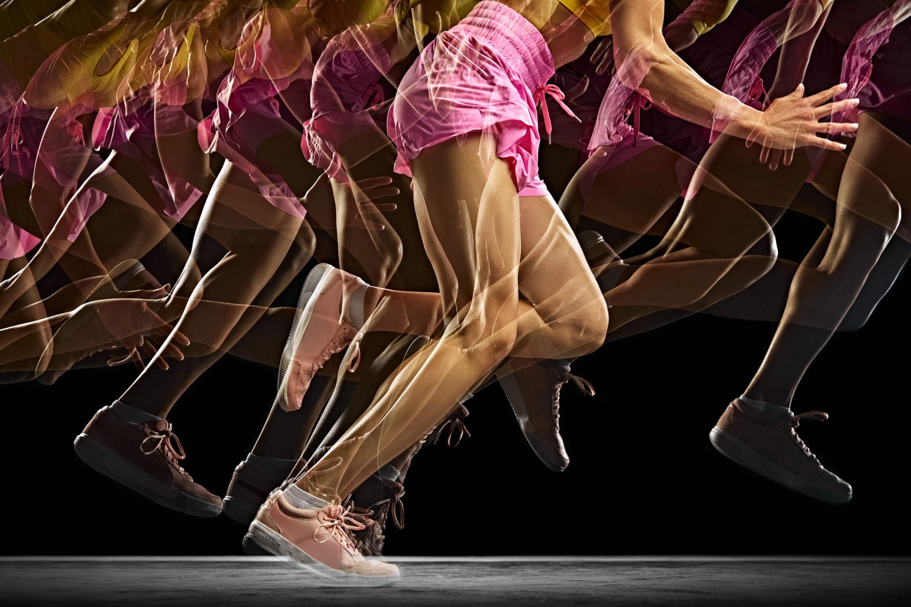 A woman's legs while she runs in pink shorts