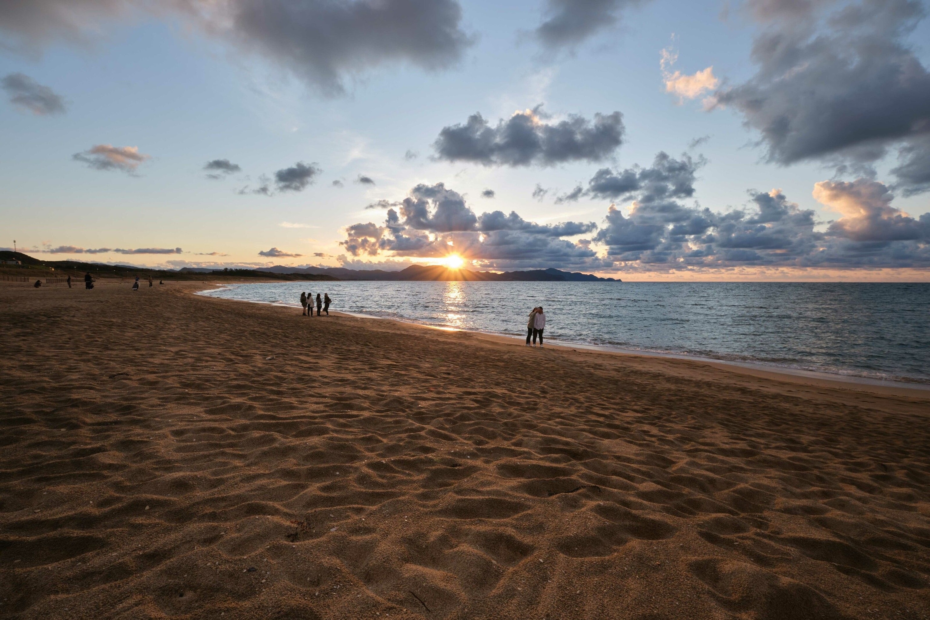 The sun sets over the ocean.