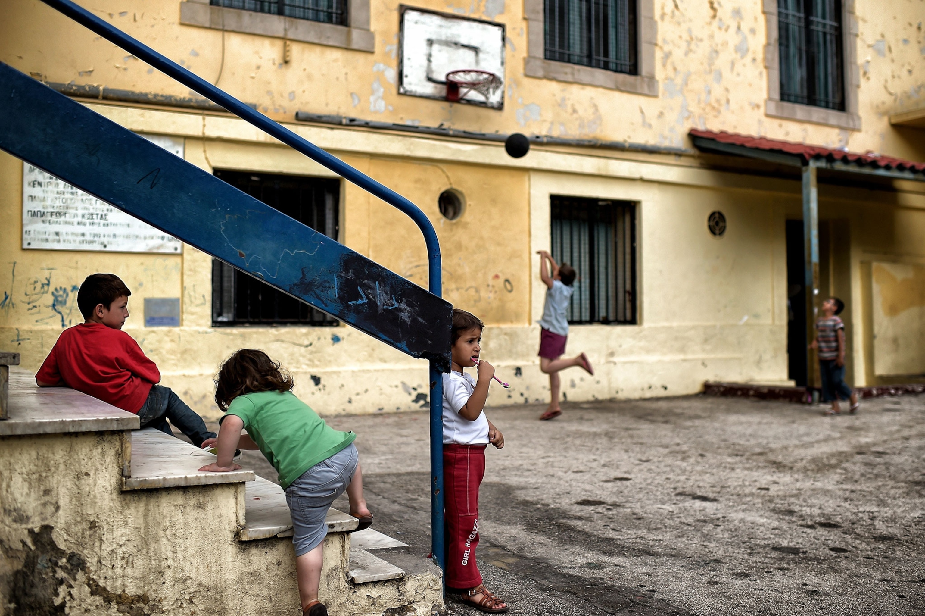 children playing in the courtyard of a school in Athens