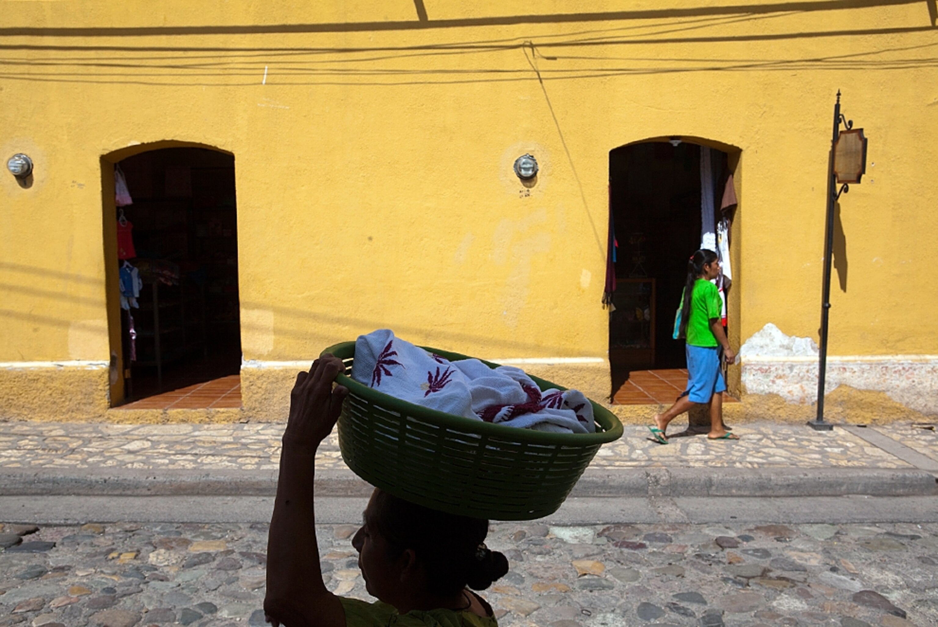 a woman carrying a basket, Copan, Honduras