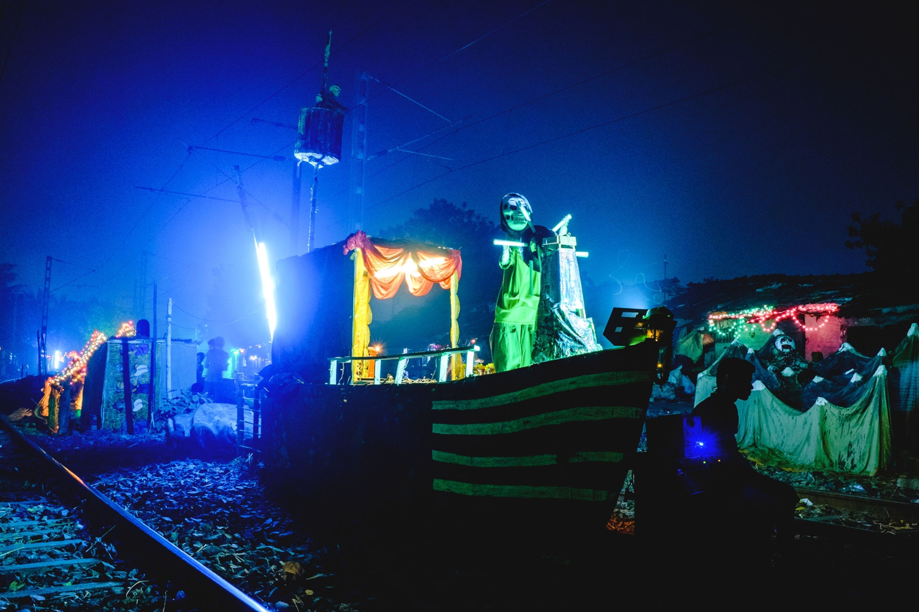 a construction for housing a deity clay idol constructed along a railroad track
