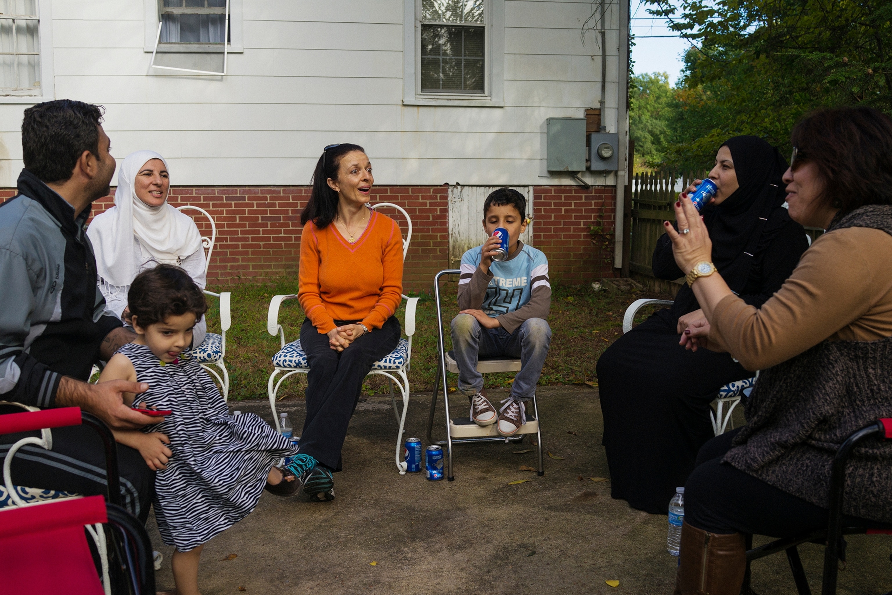 a family sitting in the backyard of their Greensboro, North Carolina home