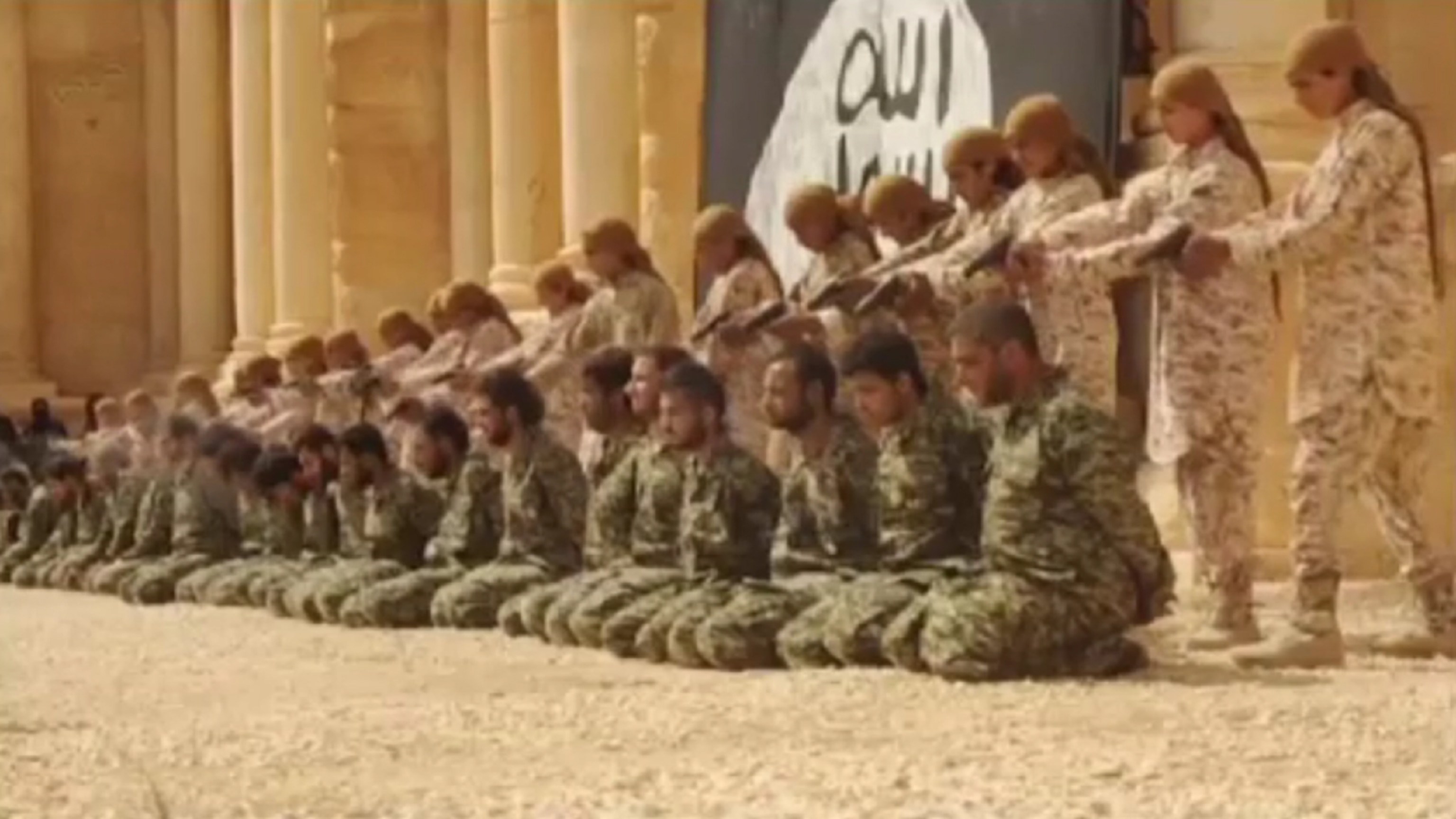 Picture from video of isis militants executing captives